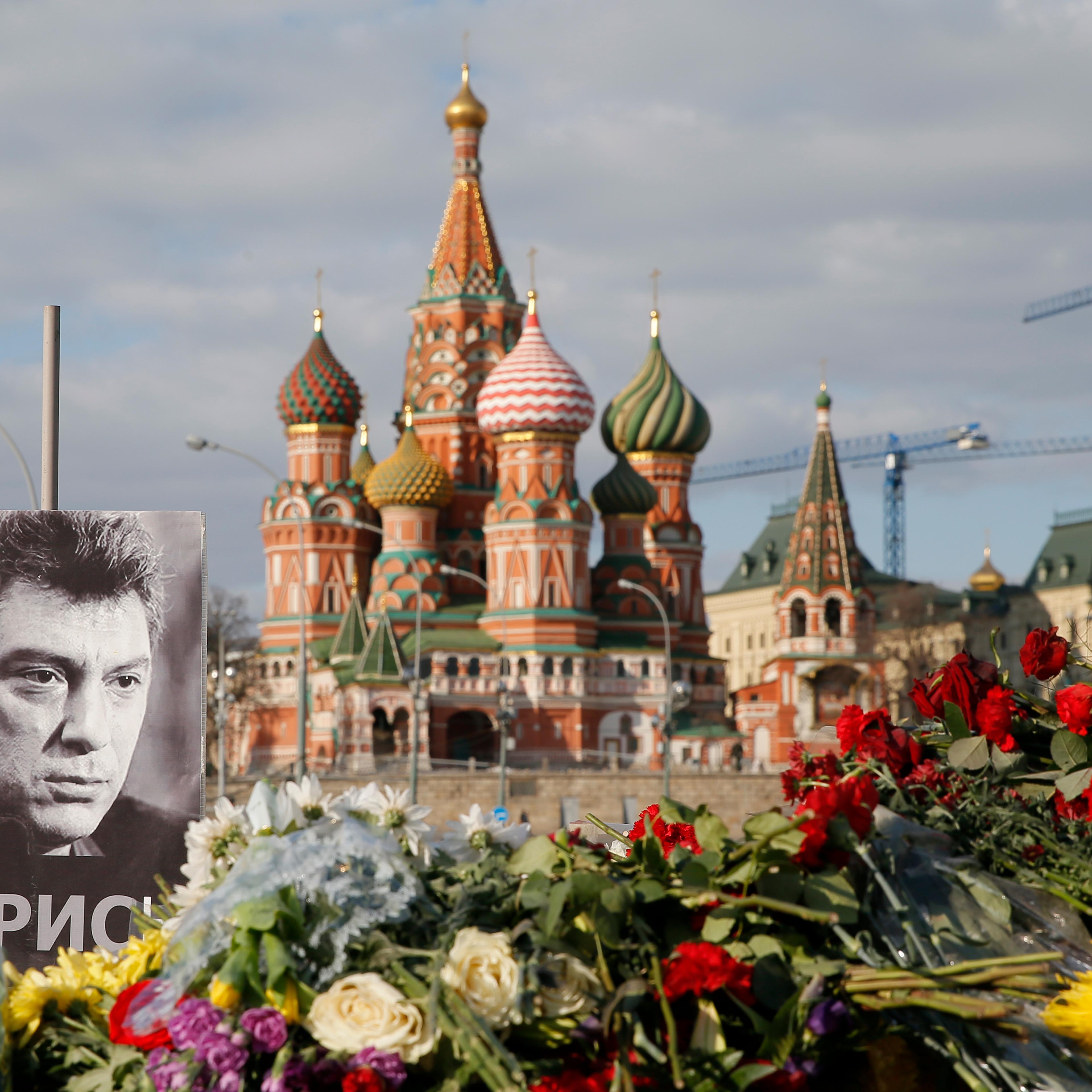 A portrait of Kremlin critic Boris Nemtsov and flowers are pictured at the site where he was killed on Feb. 27, 2015 with St. Basil's Cathedral seen in the background, at the Great Moskvoretsky Bridge in central Moscow on March 6, 2015.
