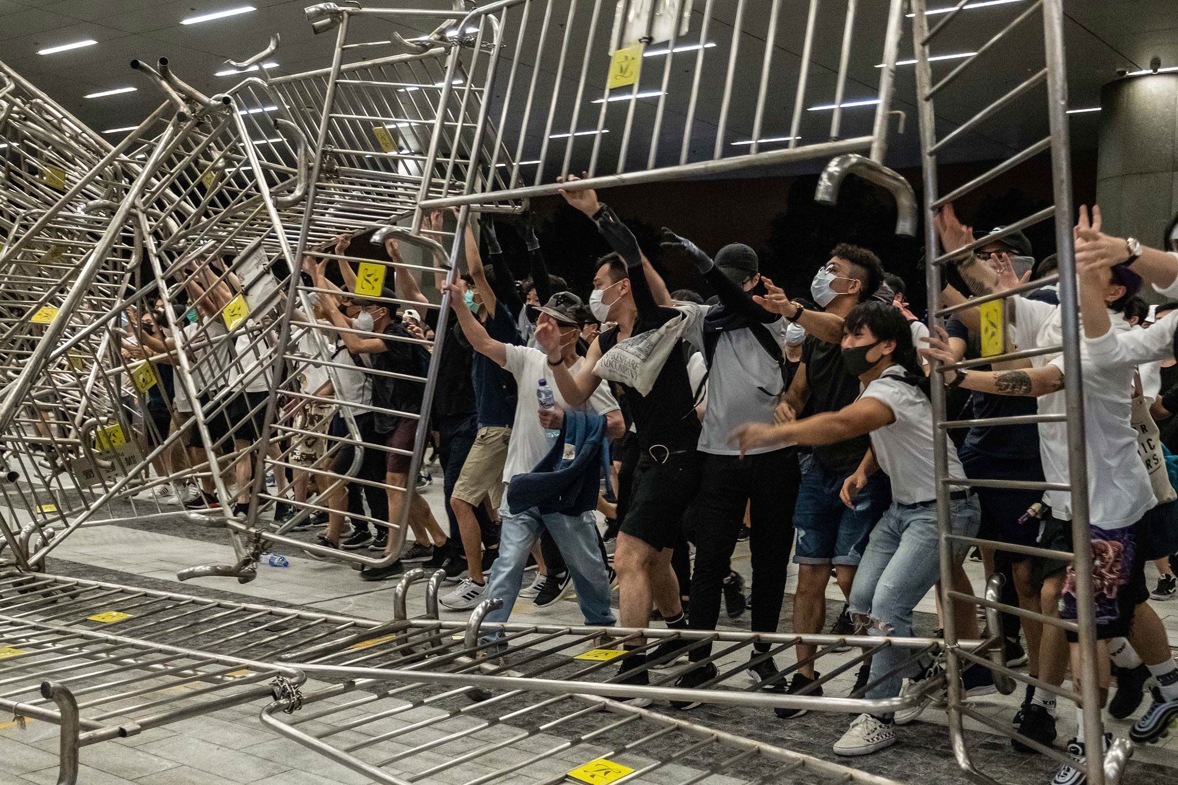 Demonstrators overturn metal barriers on June 10, as protests against the extradition law turn violent.