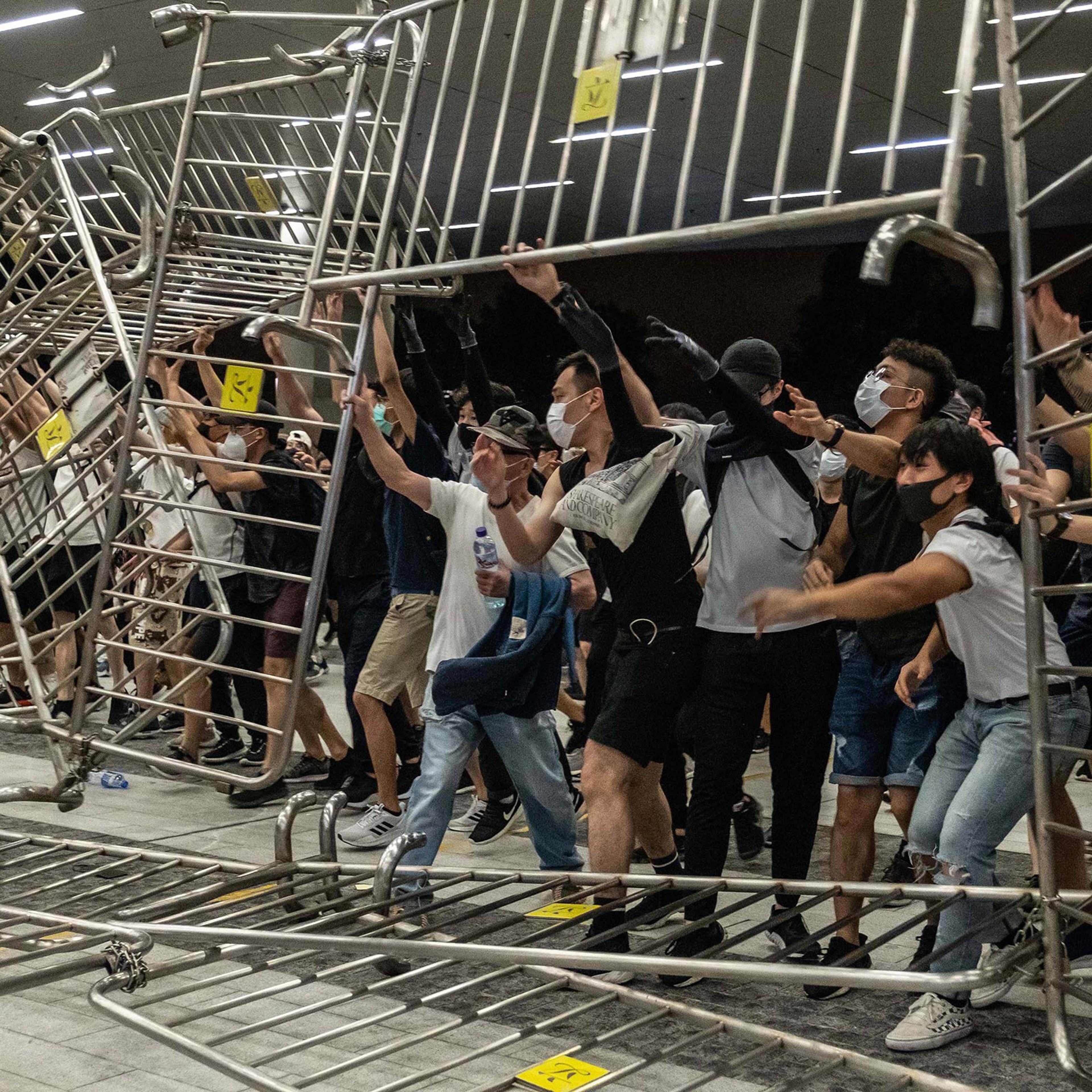 Demonstrators overturn metal barriers on June 10, as protests against the extradition law turn violent.