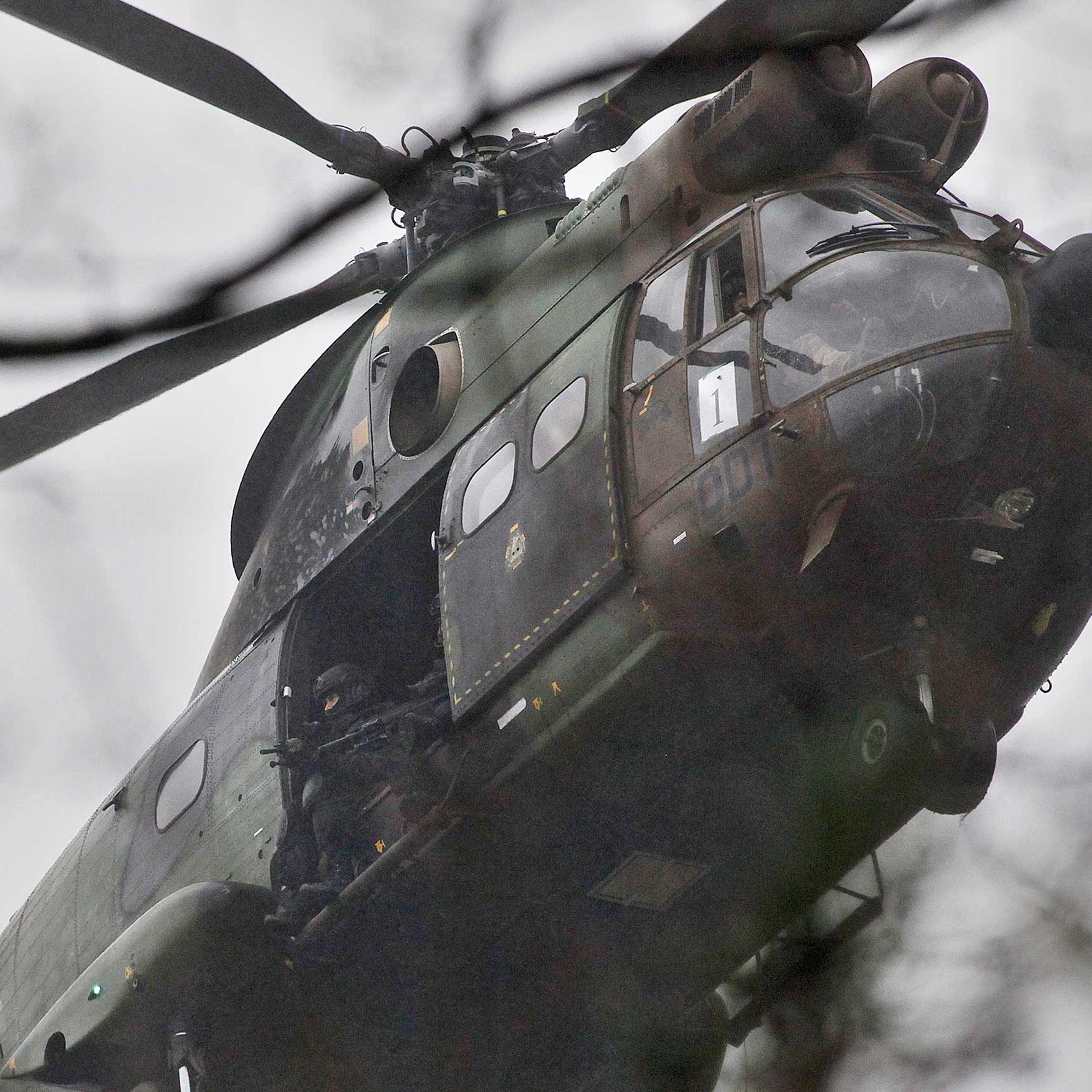 Armed security forces fly overhead in a military helicopter in Dammartin-en-Goele, northeast of Paris, Jan. 9, 2015.
