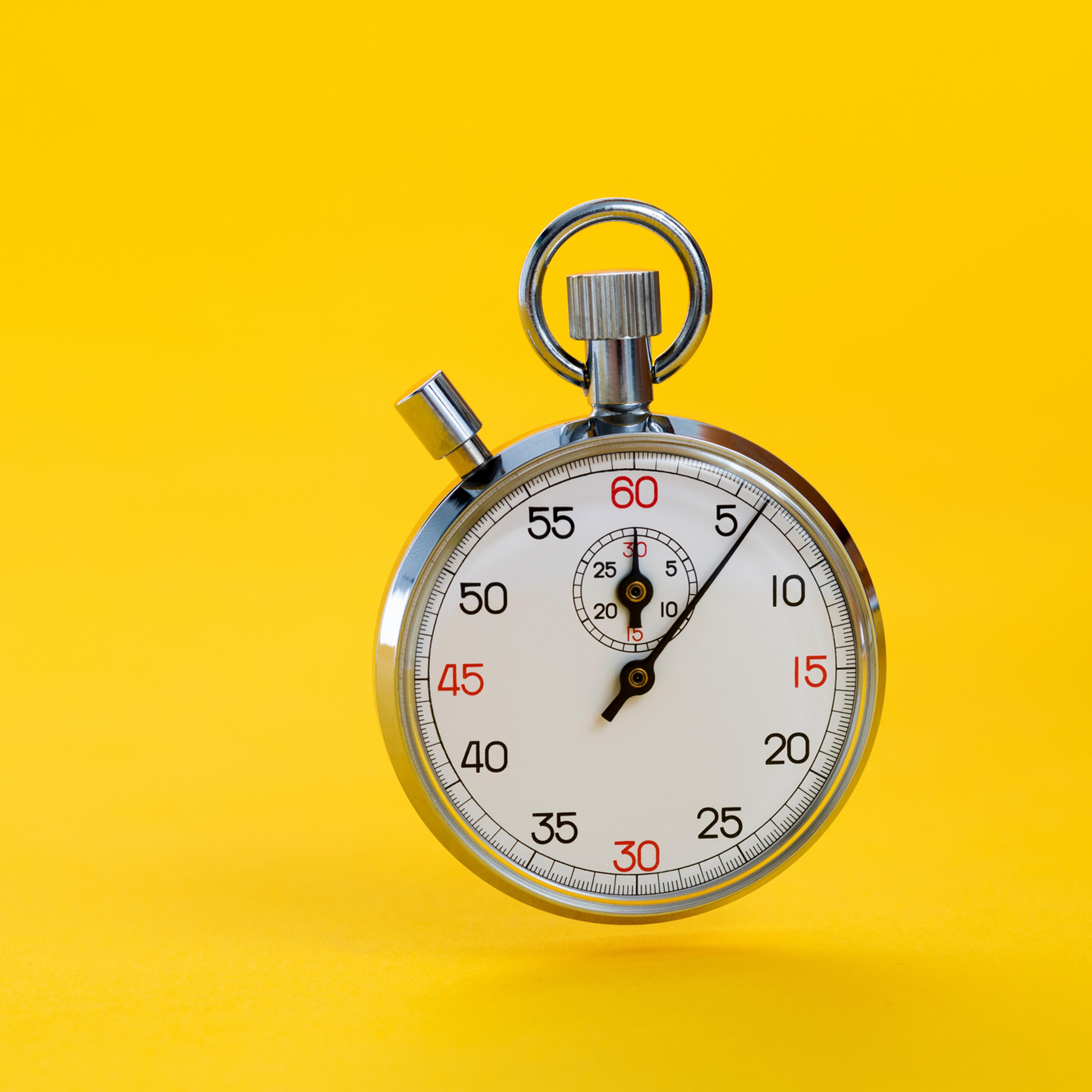 A stopwatch on yellow background