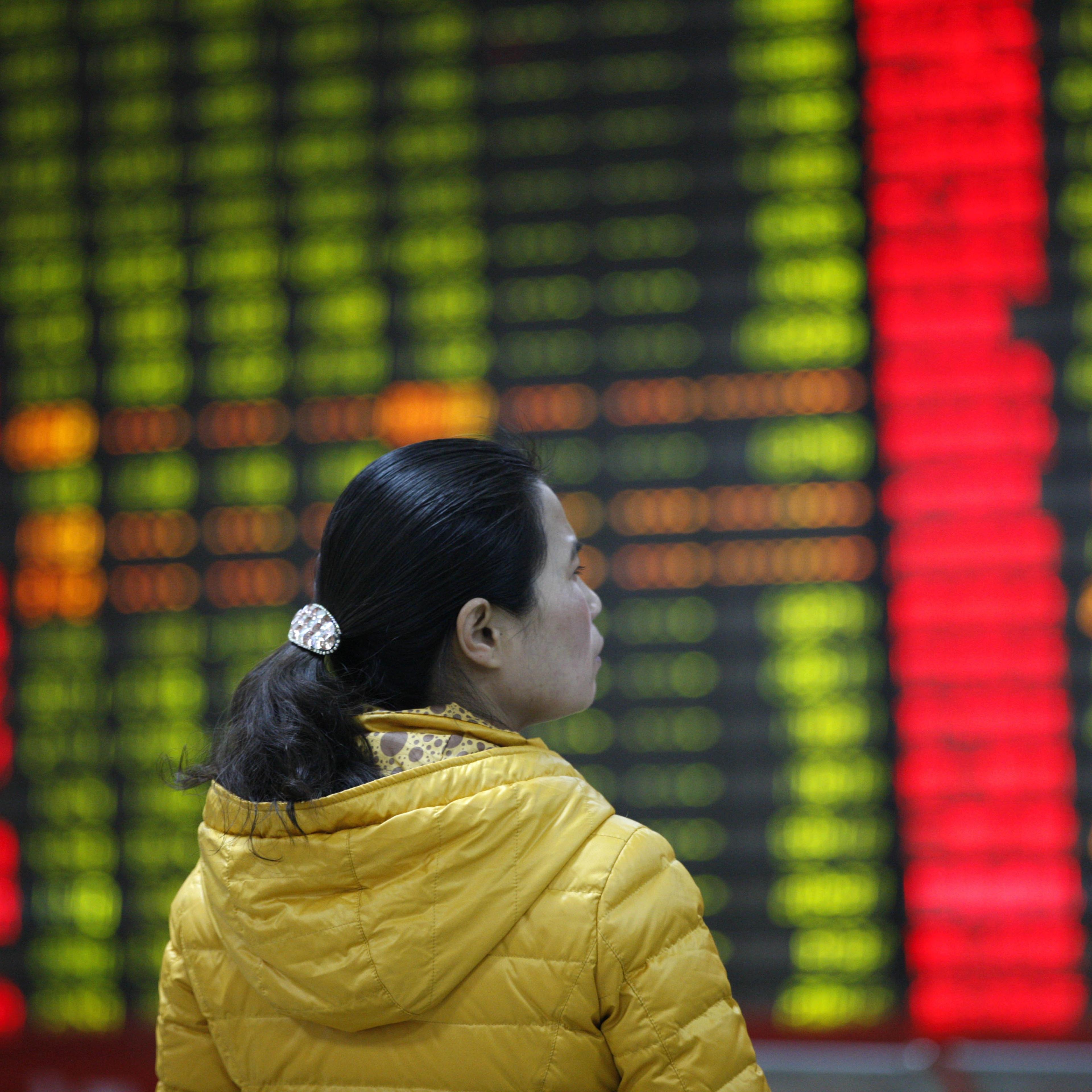 An investor watches electric board in a stock market in Huaibei, Anhui province, east China on Jan. 7, 2016.