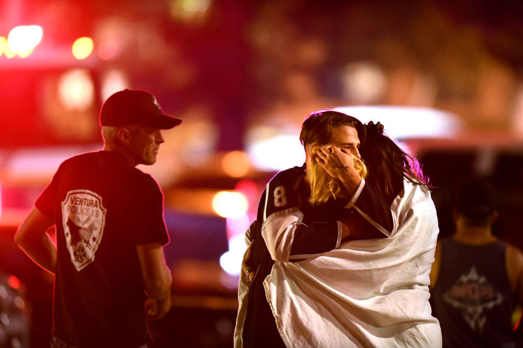 Witnesses console each other near the Borderline Bar at Thousand Oaks Shooting
