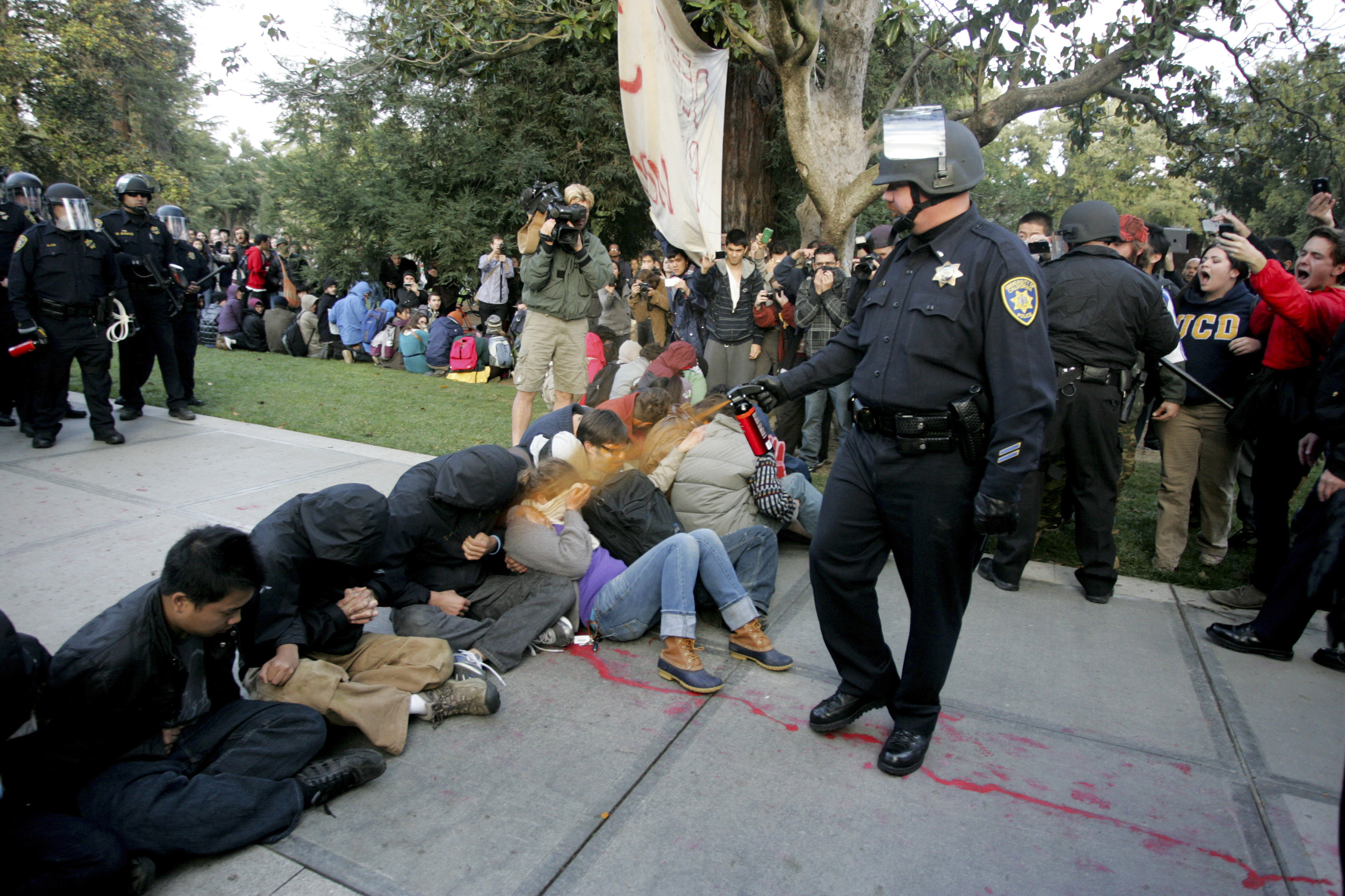 A University of California Davis police officer pepper-sprays students during their sit-in at an "Occupy UCD" demonstration in Davis, Calif. on Nov. 18, 2011.
