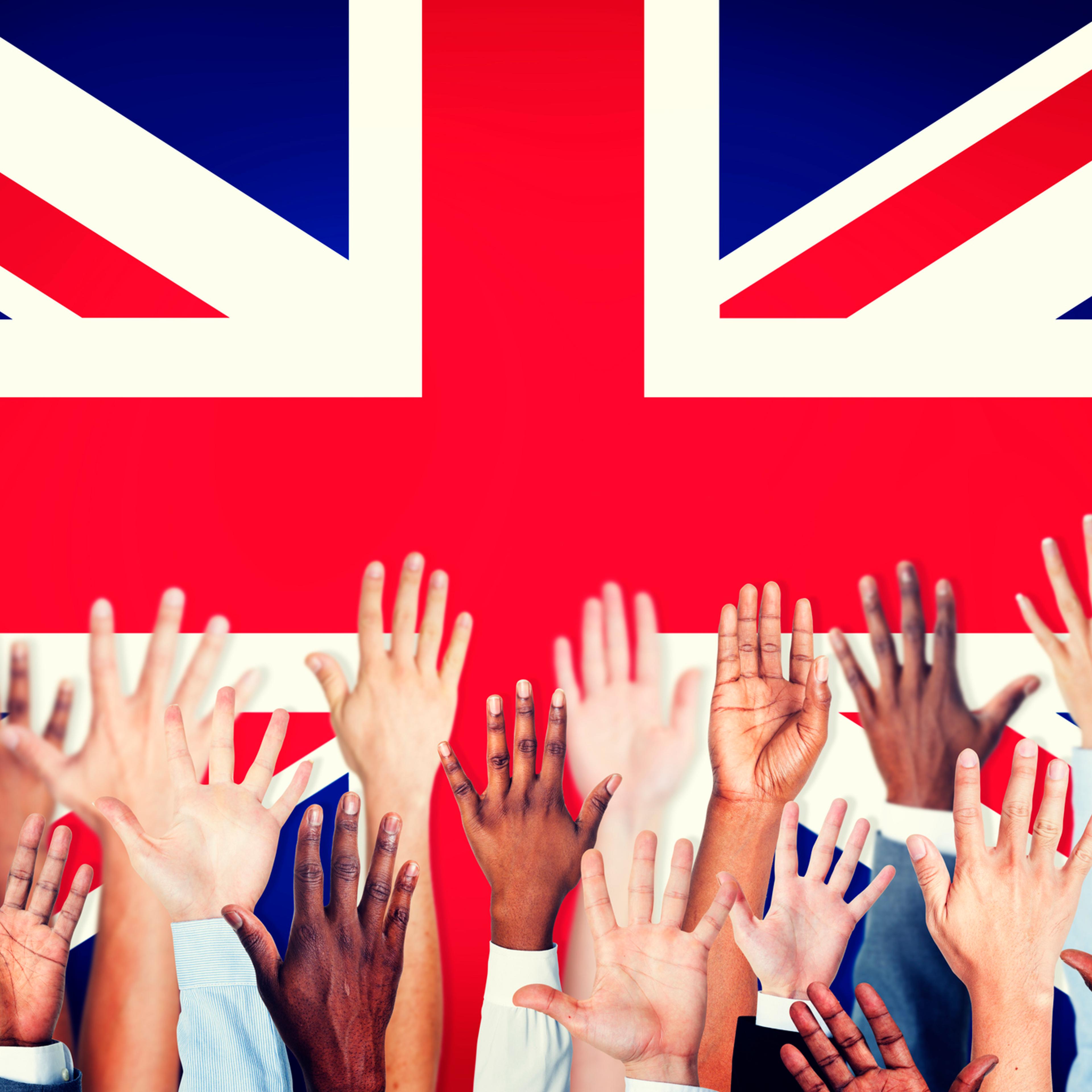 Group of Multi-Ethnic Arms Raised with Flag of United Kingdom