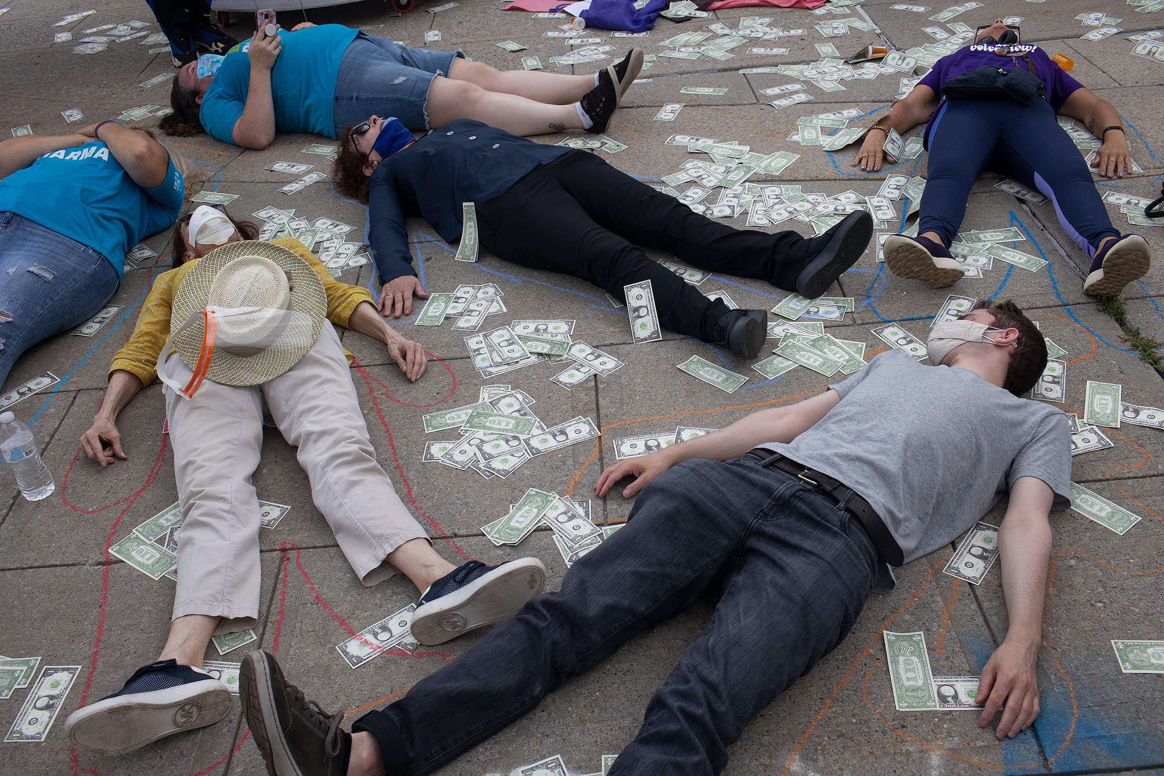 Friends and family members of people who have died during the opioid epidemic protest against a bankruptcy deal with Purdue Pharmaceuticals that allows the Sackler family to avoid criminal prosecution and to keep billions of dollars in private wealth, on August 9, 2021 outside the Federal courthouse in White Plains, New York.