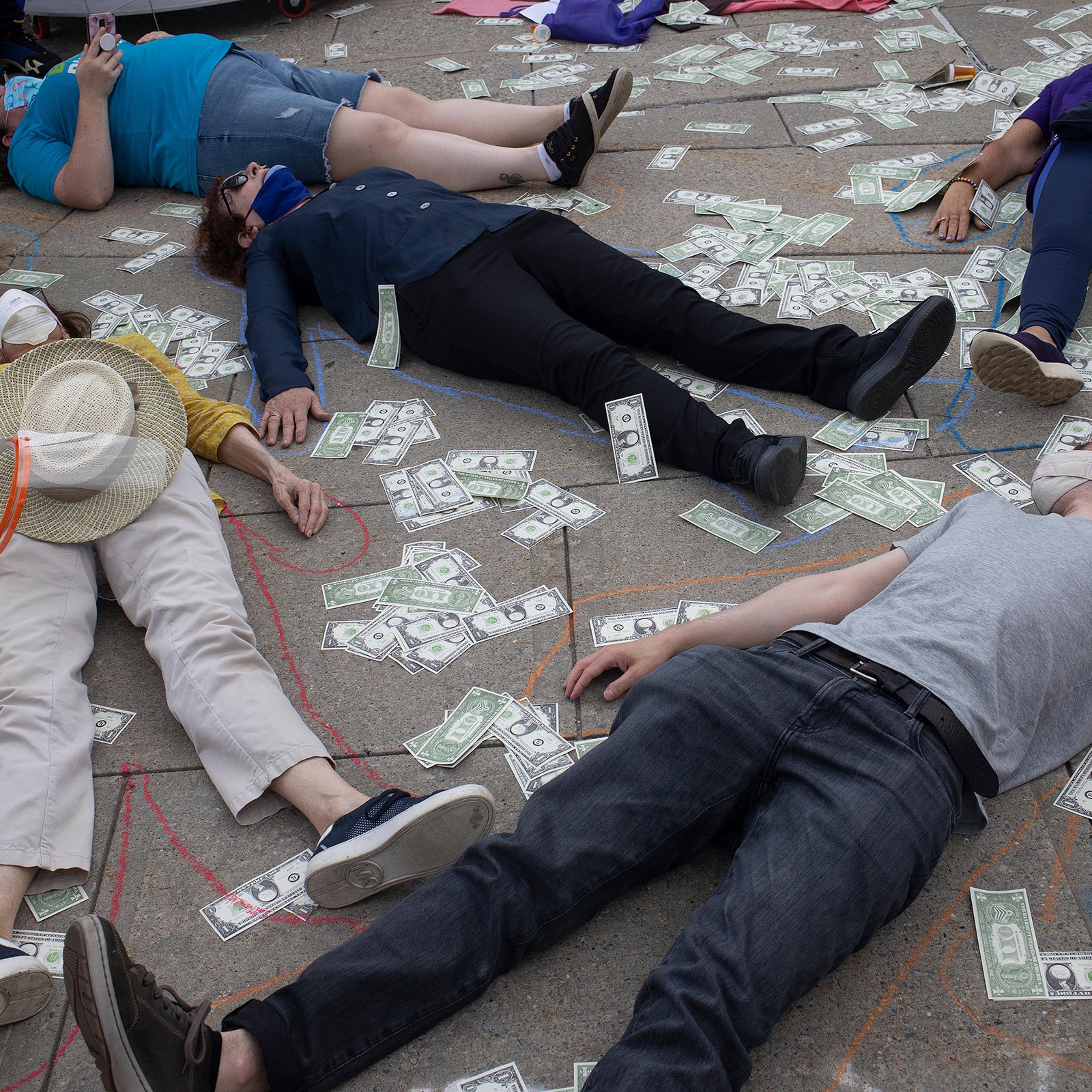 Friends and family members of people who have died during the opioid epidemic protest against a bankruptcy deal with Purdue Pharmaceuticals that allows the Sackler family to avoid criminal prosecution and to keep billions of dollars in private wealth, on August 9, 2021 outside the Federal courthouse in White Plains, New York.