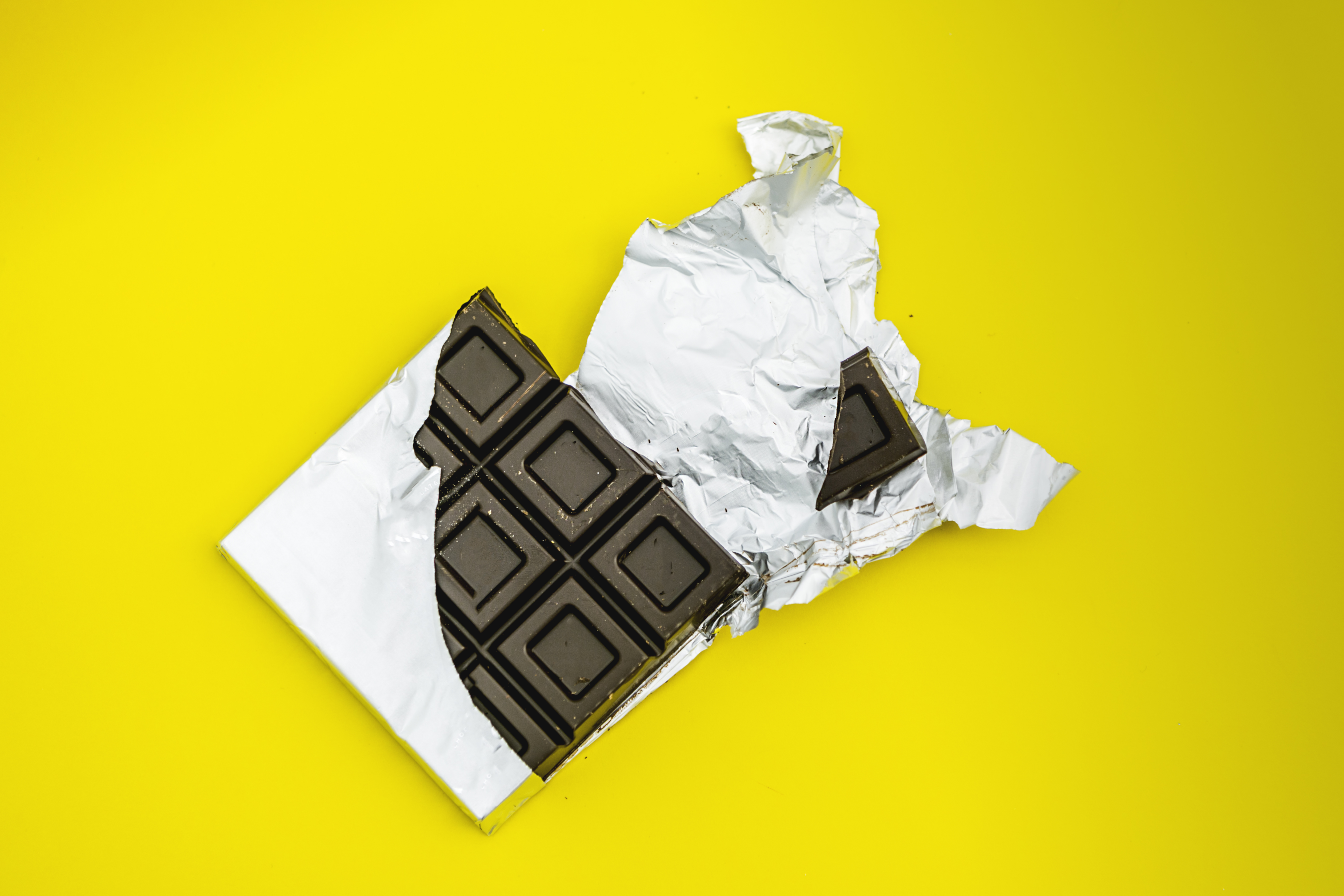 bitten chocolate bar in yellow background