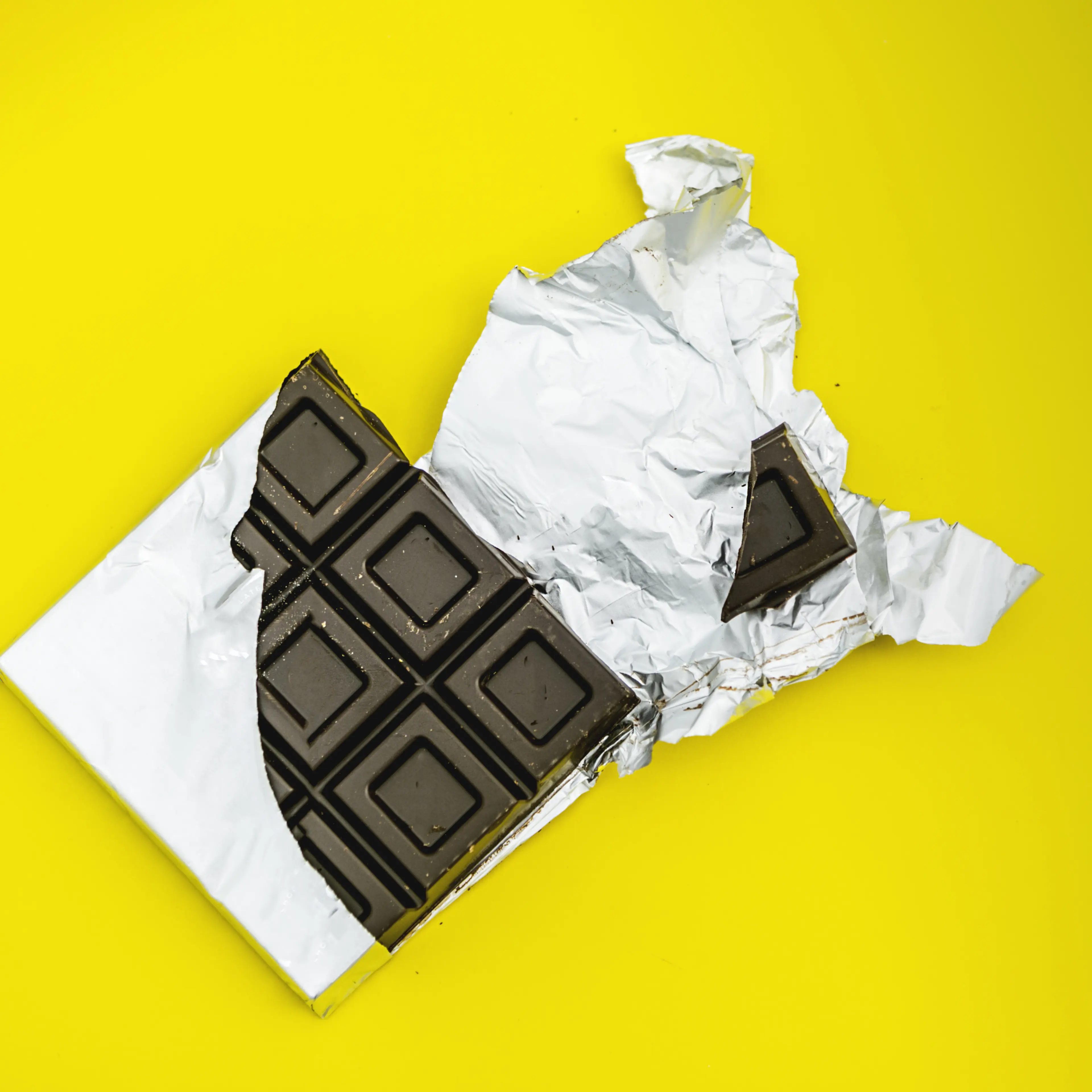 bitten chocolate bar in yellow background
