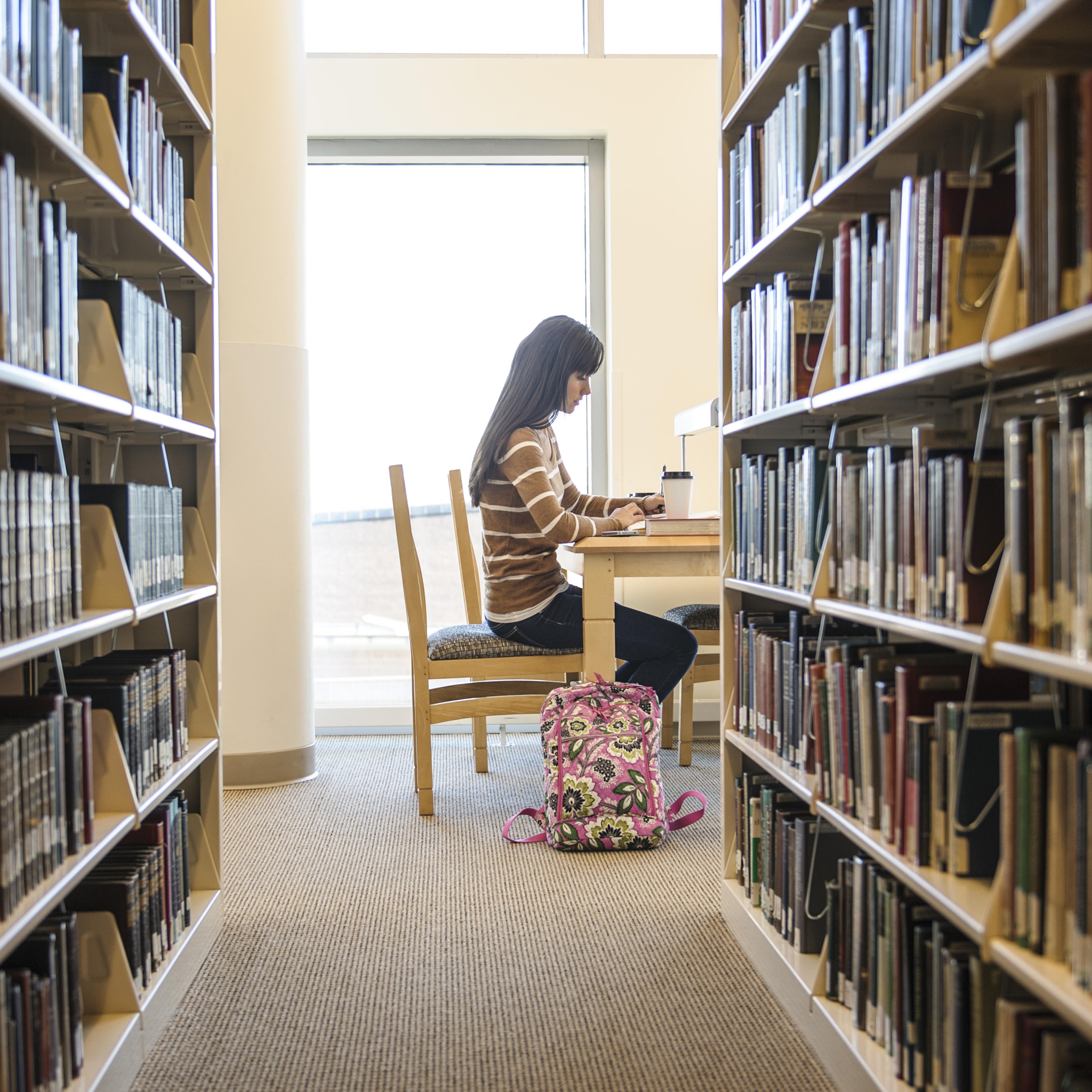 Student working at desk in library