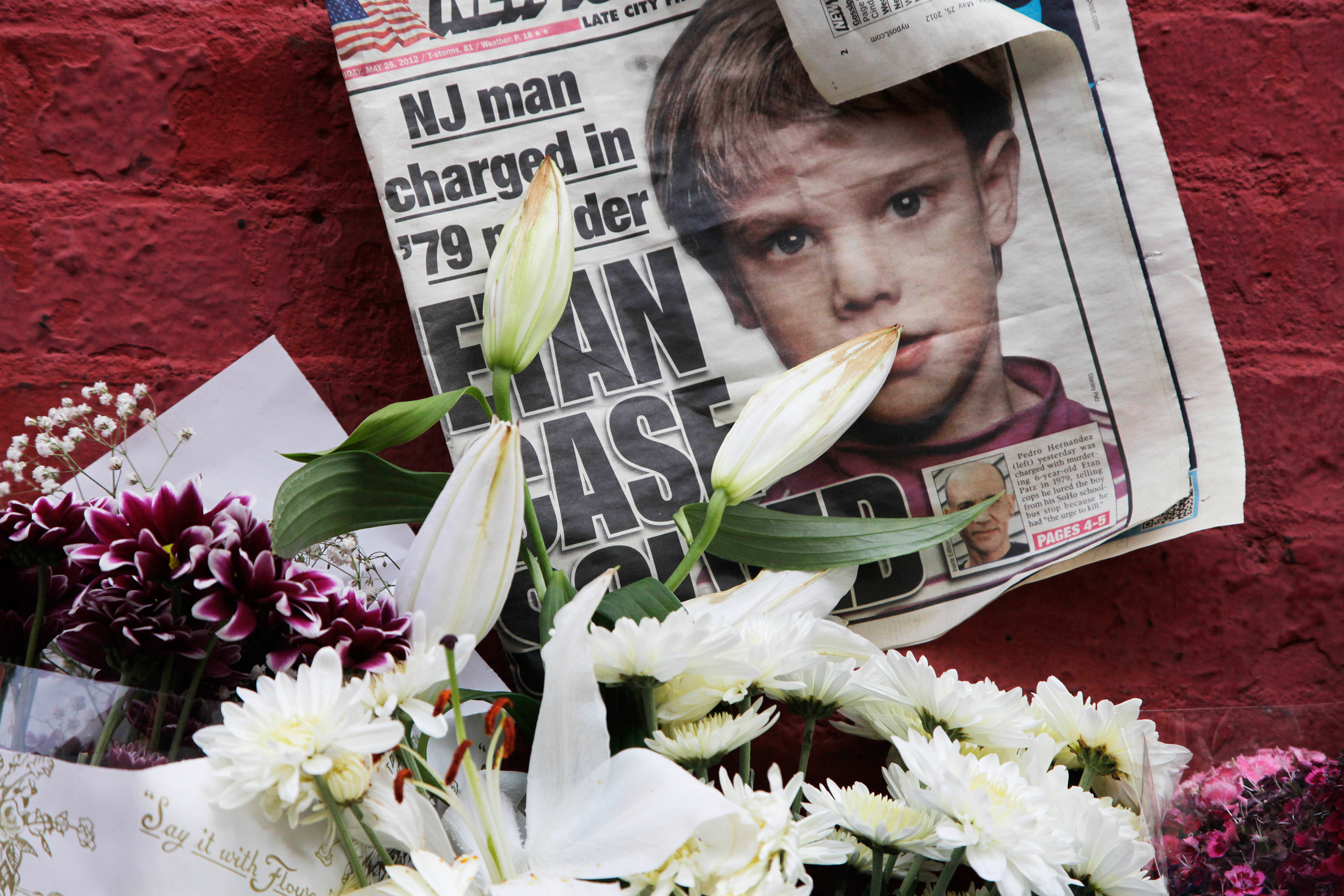 A newspaper with a photograph of Etan Patz is part of a makeshift memorial in the SoHo neighborhood of New York, Monday, May 28, 2012. For prosecutors, the work is just beginning after the astonishing arrest last week of a man who police say confessed to