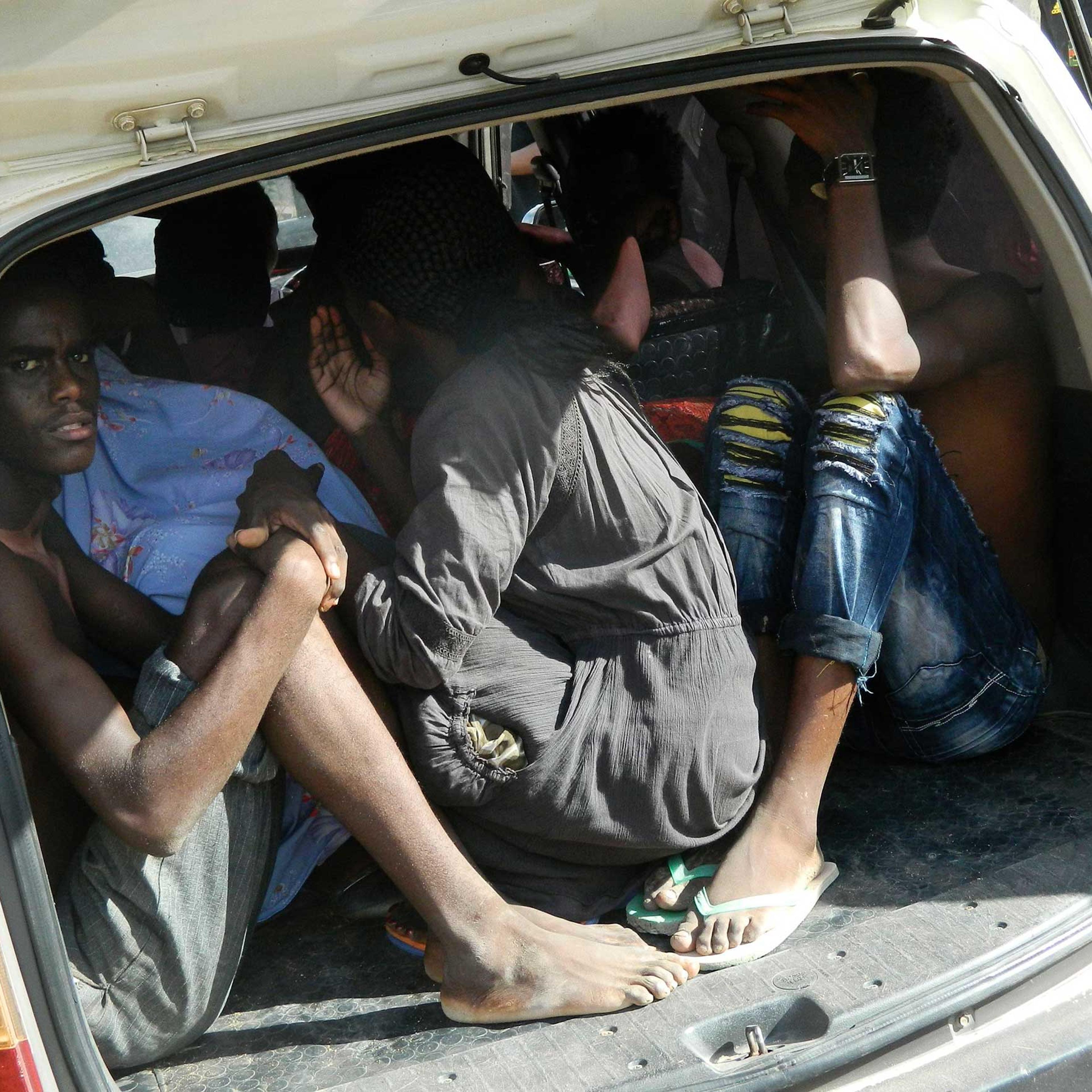 Students of the Garissa University College take shelter in a vehicle after fleeing from an attack by gunmen in Garissa, Kenya, April 2, 2015.