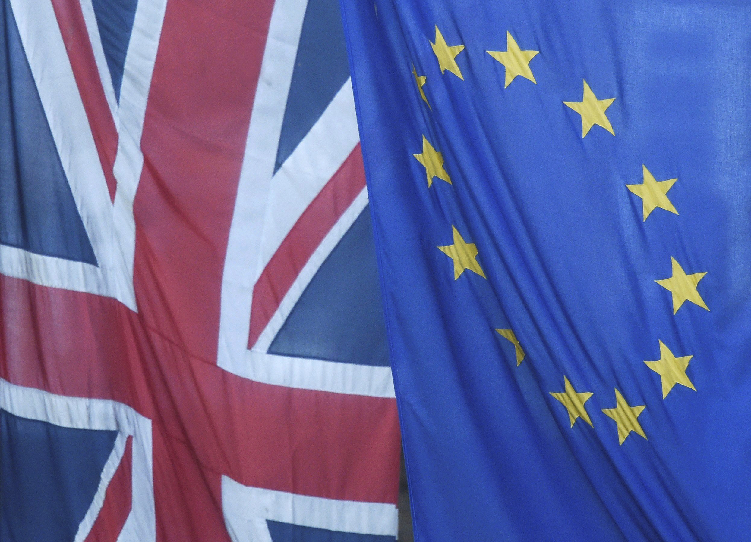 A Union Jack flag flies next to the flag of the European Union in Westminster, London, on June 24, 2016.