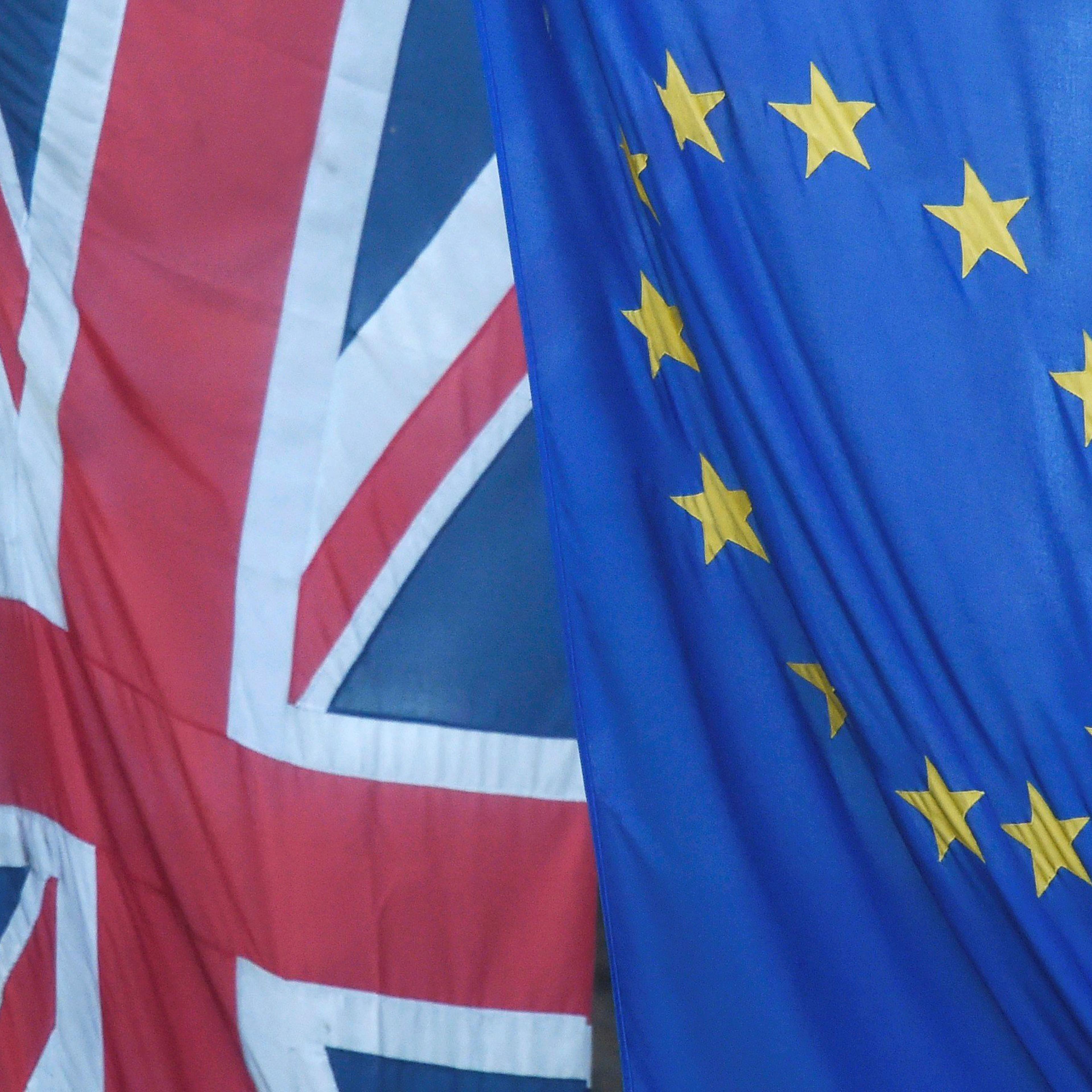 A Union Jack flag flies next to the flag of the European Union in Westminster, London, on June 24, 2016.