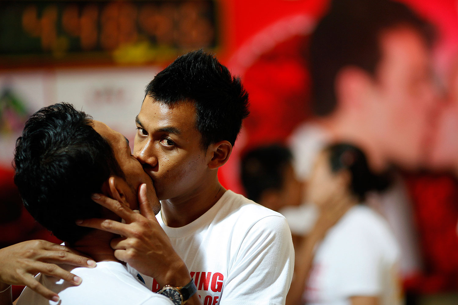 Two men kiss among straight couples participating in a longest continuous kiss competition in Pattaya, Thailand, in Feb. 2012