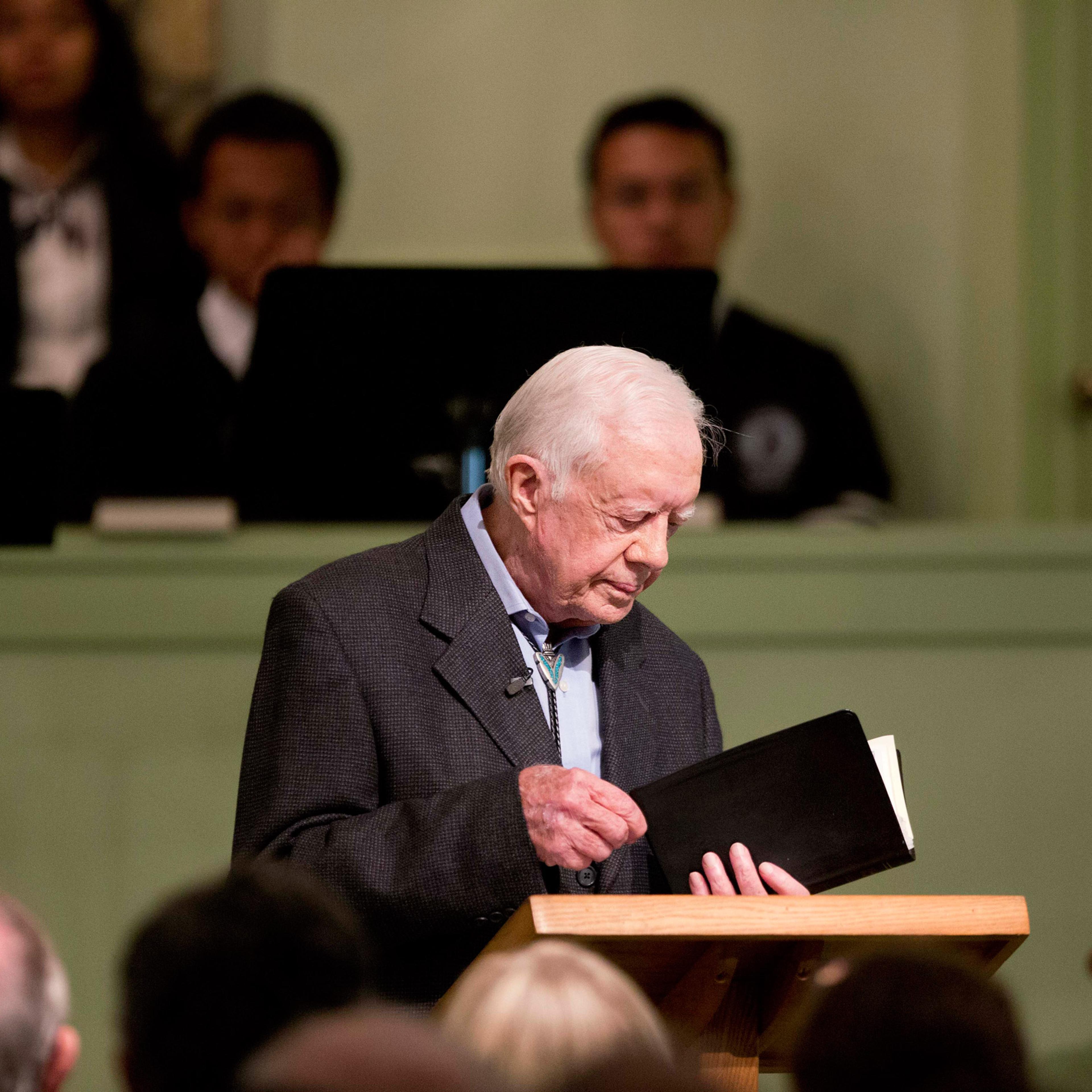 Former President Jimmy Carter opens up a Bible while teaching Sunday School class at Maranatha Baptist Church in his hometown Sunday, Aug. 23, 2015, in Plains, Ga. The 90-year-old Carter gave one lesson to about 300 people filling the small Baptist churc