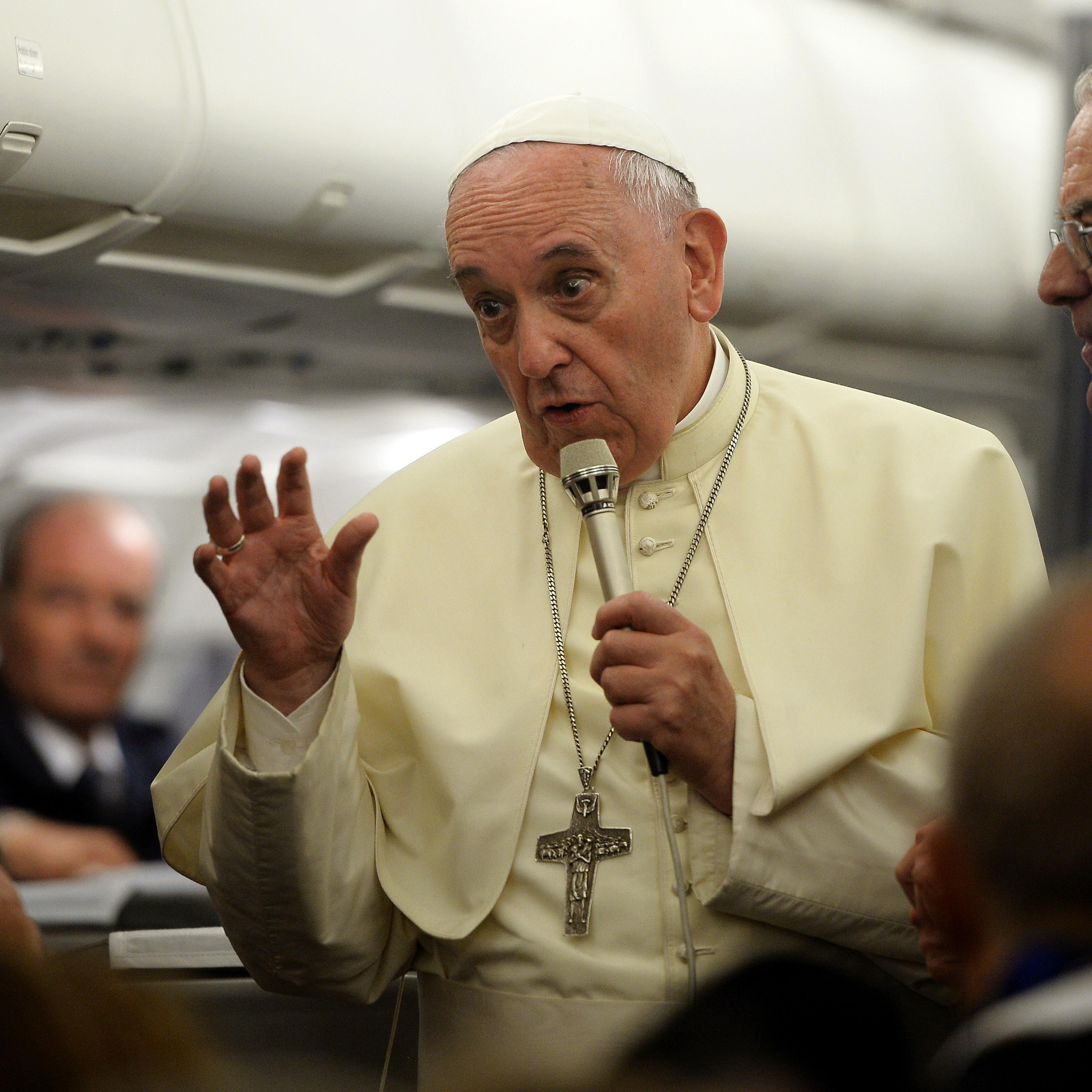 Pope Francis gives a press conference as he flies back to Rome from Tirana, on September 21, 2014.