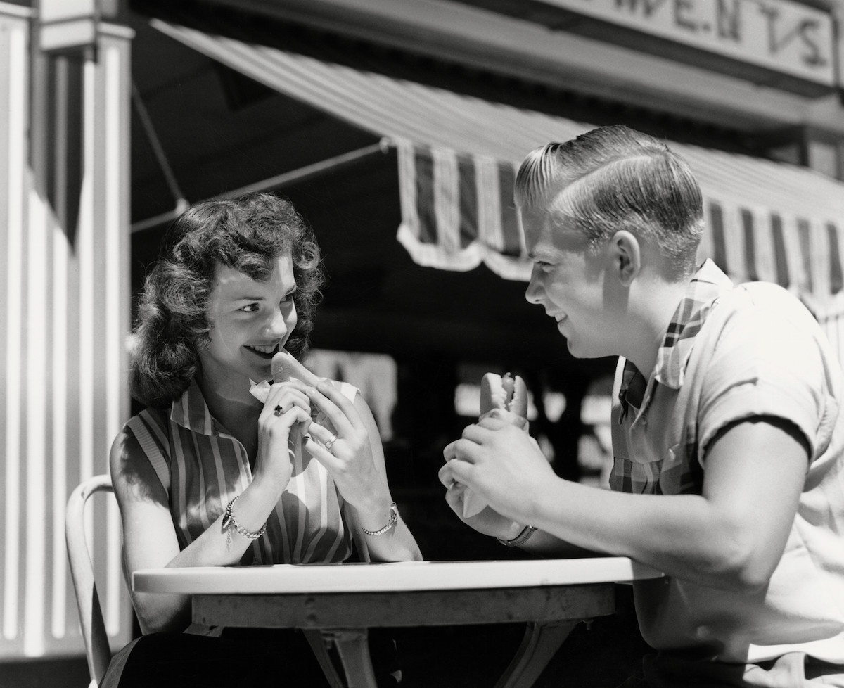 Couple eating hot dogs