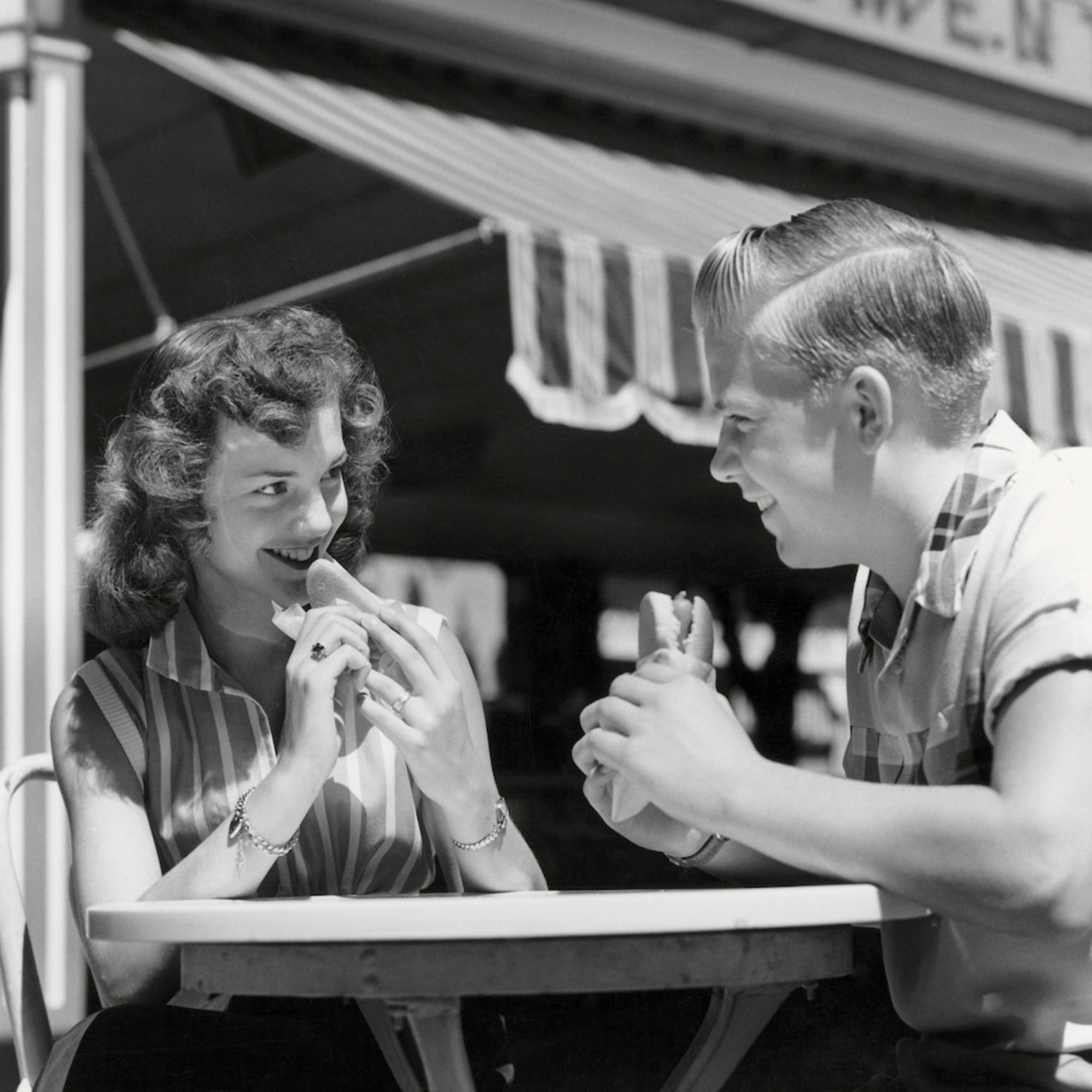 Couple eating hot dogs
