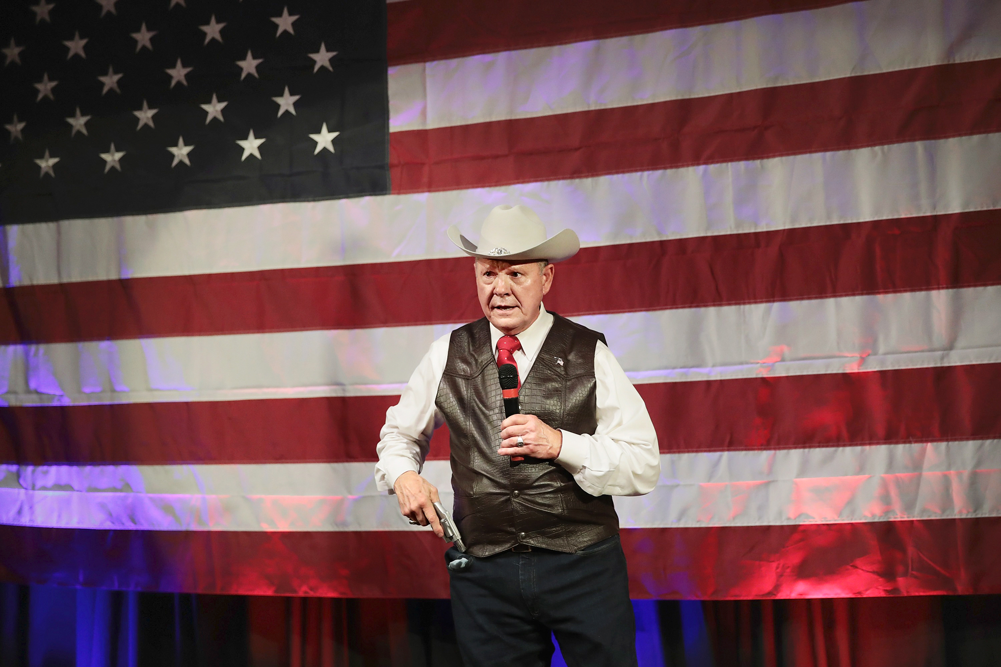 Moore brandishes a pistol while speaking about Second Amendment rights