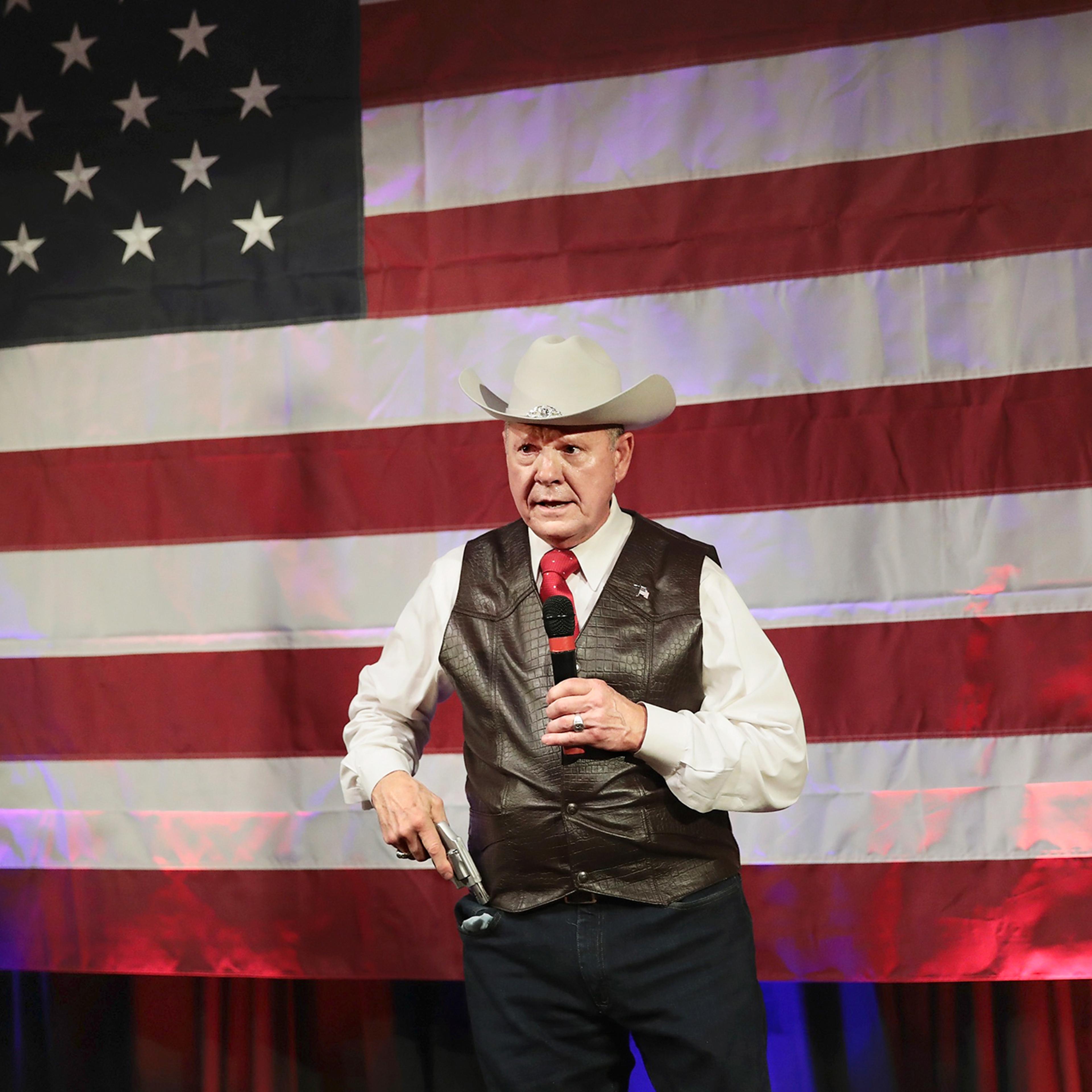 Moore brandishes a pistol while speaking about Second Amendment rights