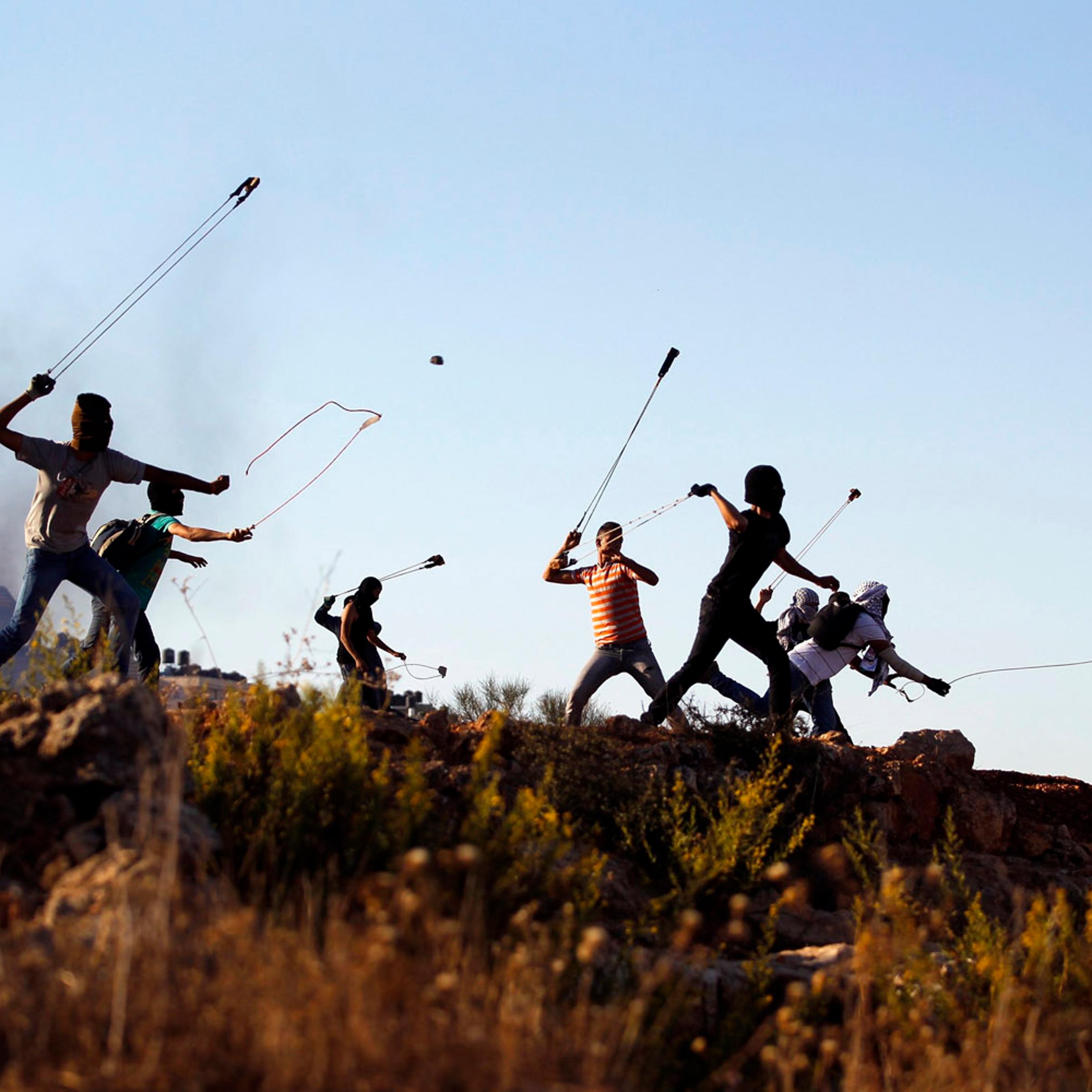 Palestinian protesters hurl rocks at Israeli soldiers during clashes in Betunia, near the West Bank city of Ramallah