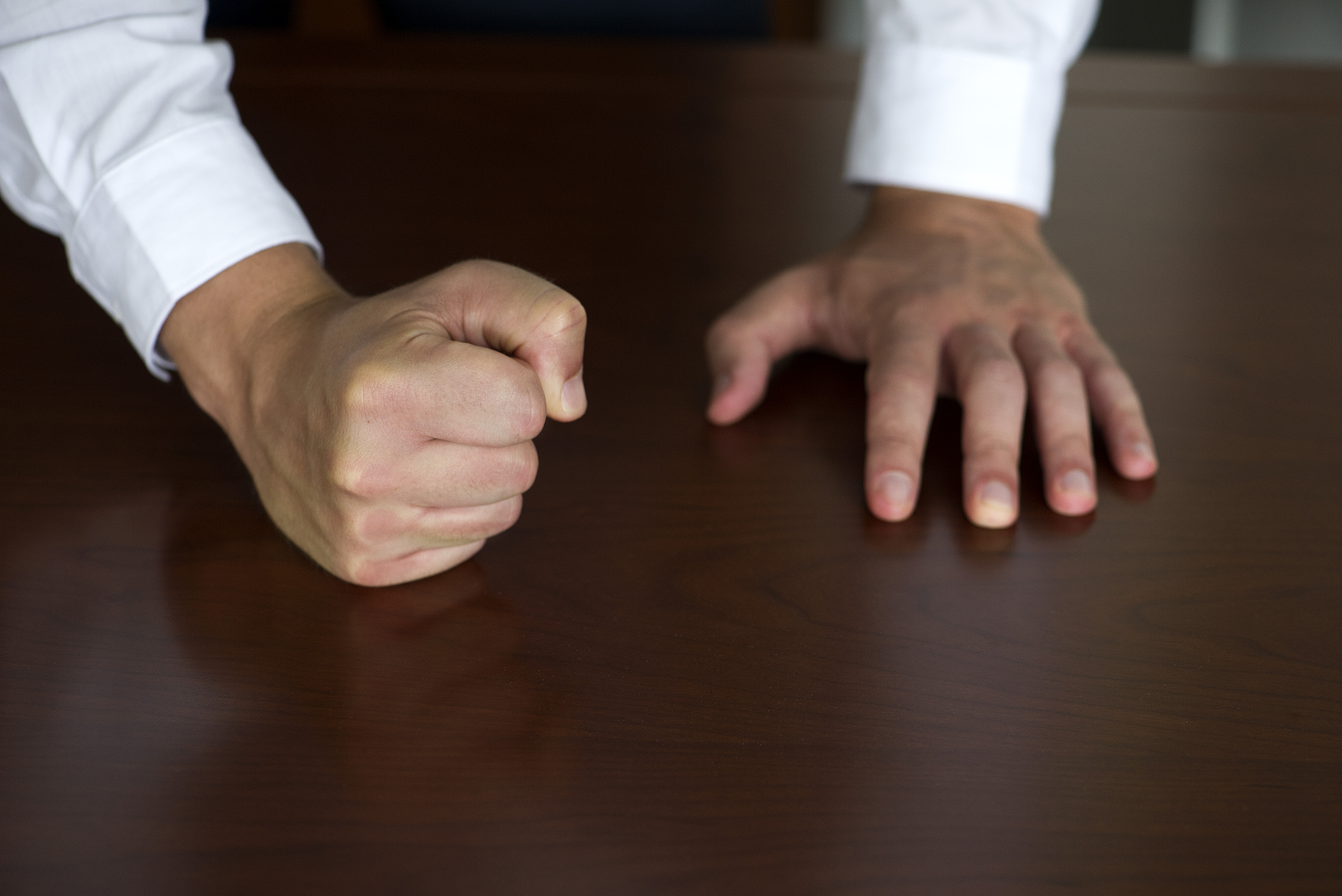Businessman pounding fist on table