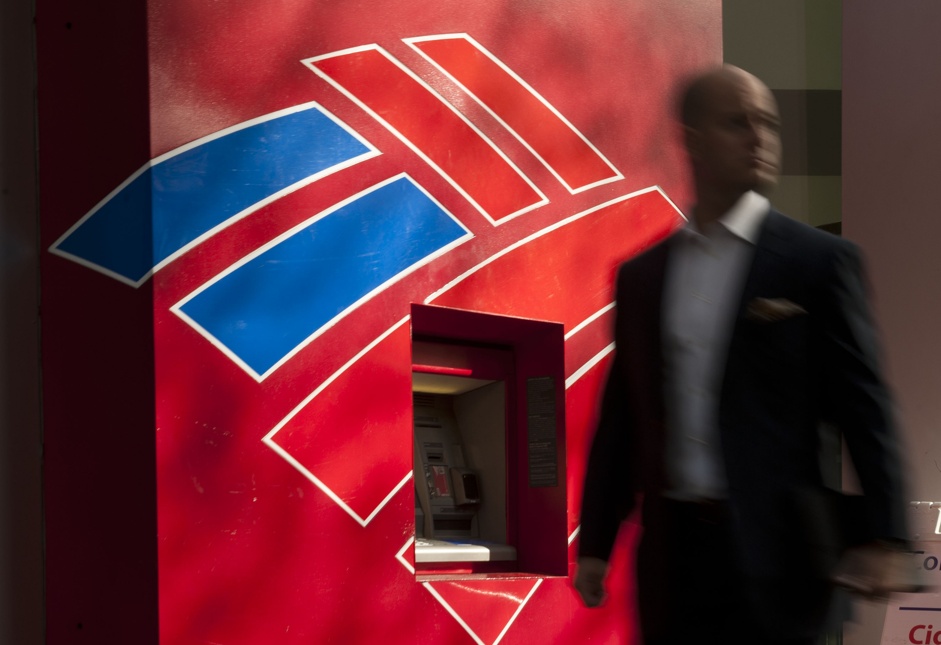 A man walks past a Bank of America ATM in Charlotte, N.C., May 8, 2013.