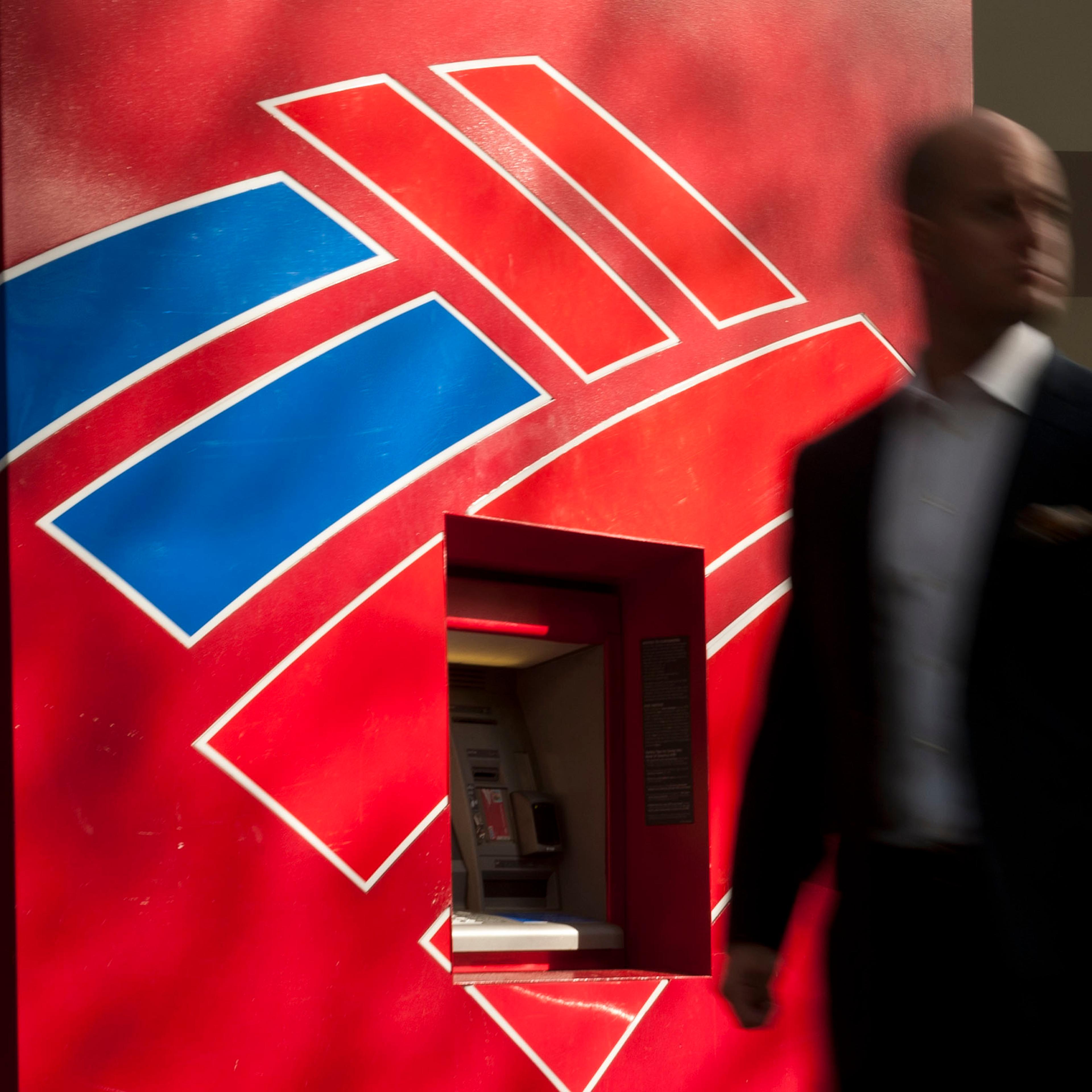 A man walks past a Bank of America ATM in Charlotte, N.C., May 8, 2013.