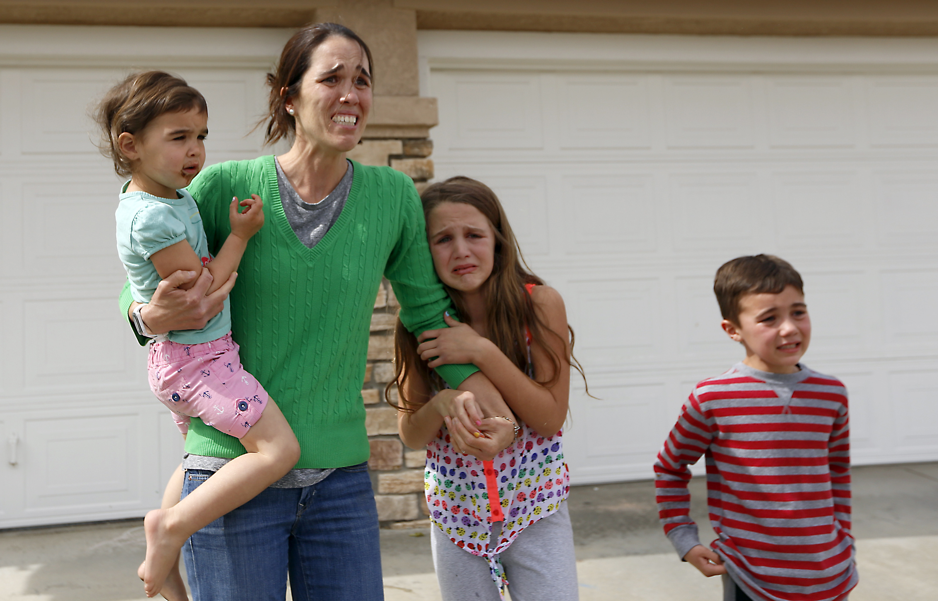 Summer Page runs out of her home after social workers took her foster child way. She is watching them drive off. Santa Clarita, Calif., March 21, 2016