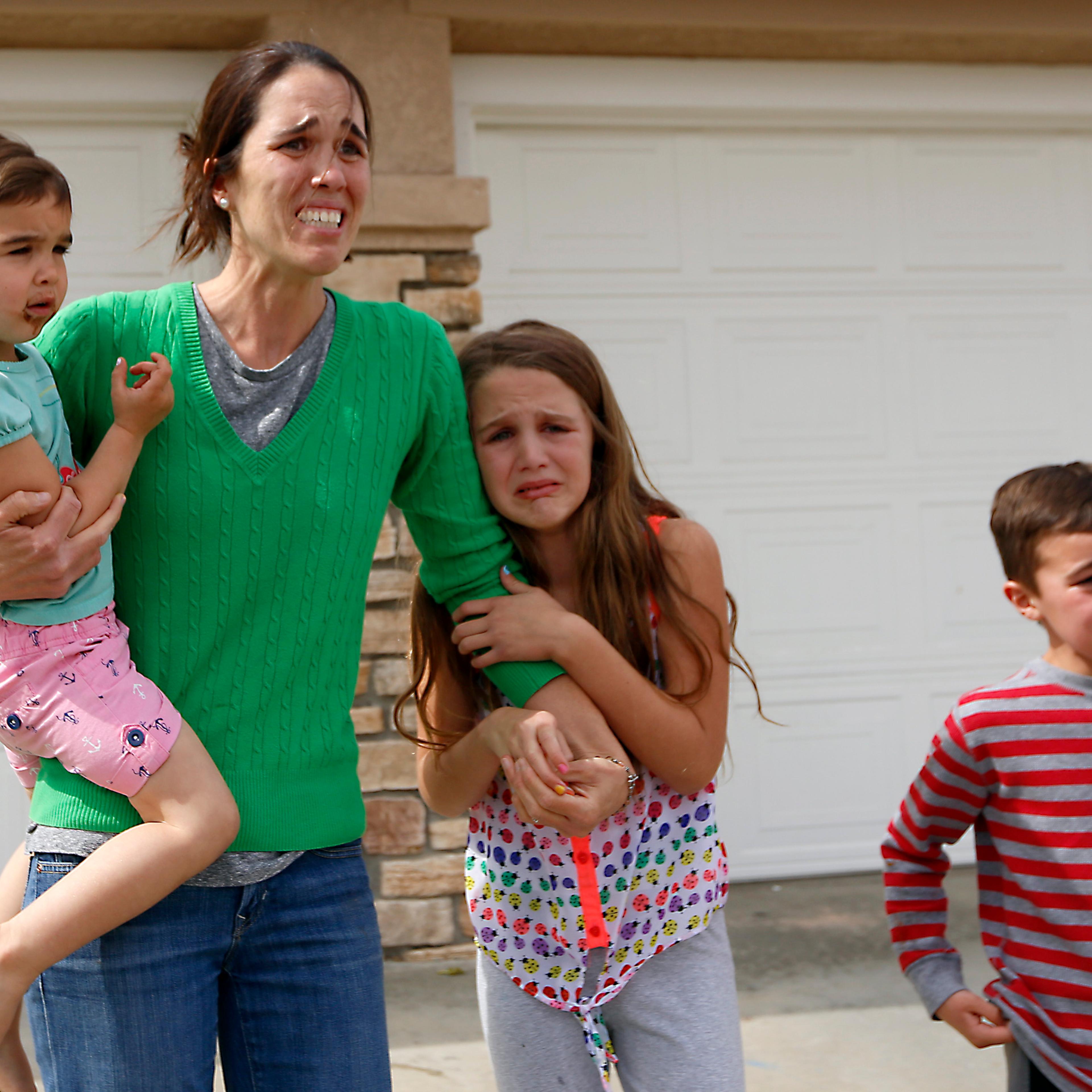 Summer Page runs out of her home after social workers took her foster child way. She is watching them drive off. Santa Clarita, Calif., March 21, 2016