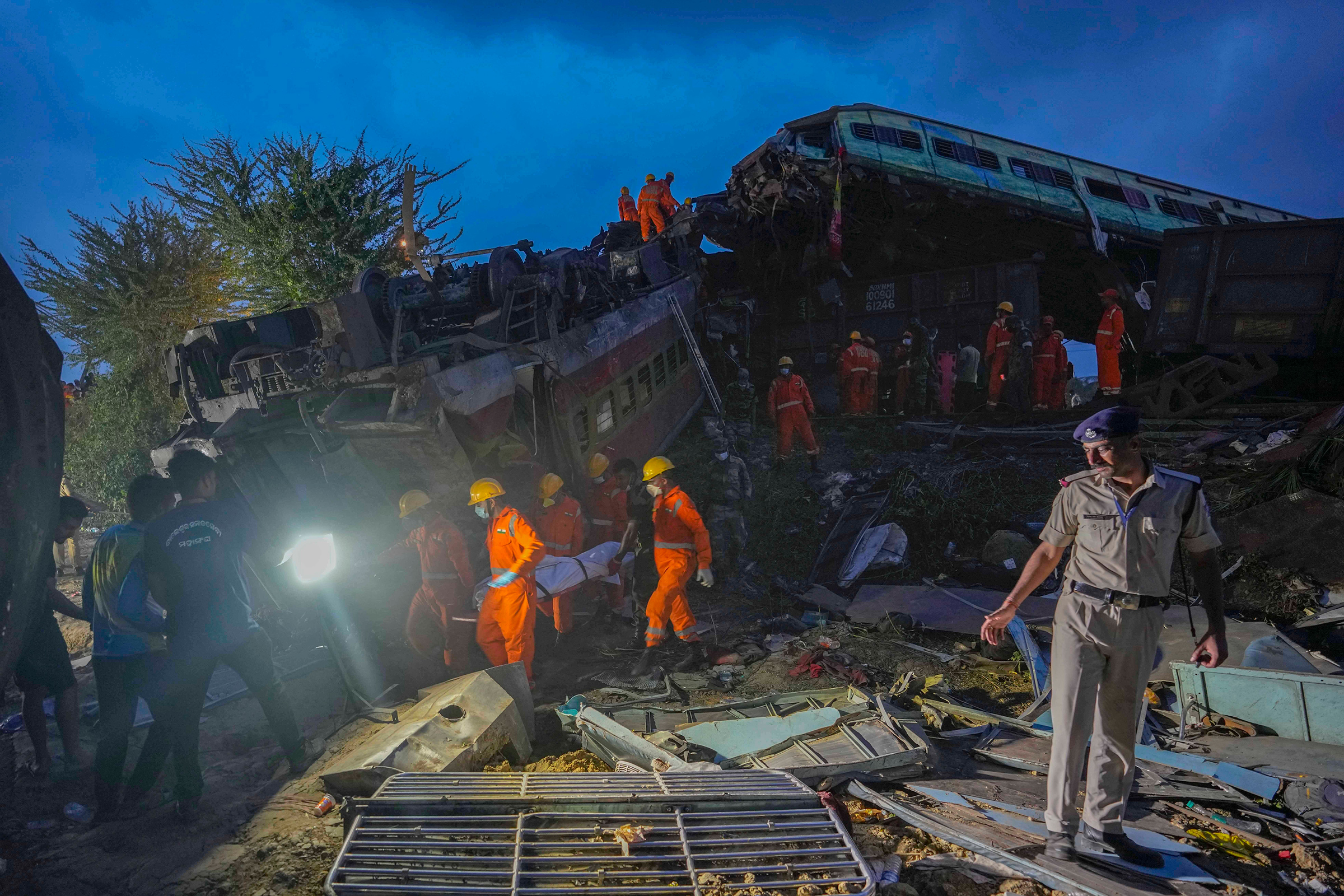 Rescuers carry the body of a victim at the site of passenger trains that derailed in Balasore, in the eastern Indian state of Orissa, India, on June 3.