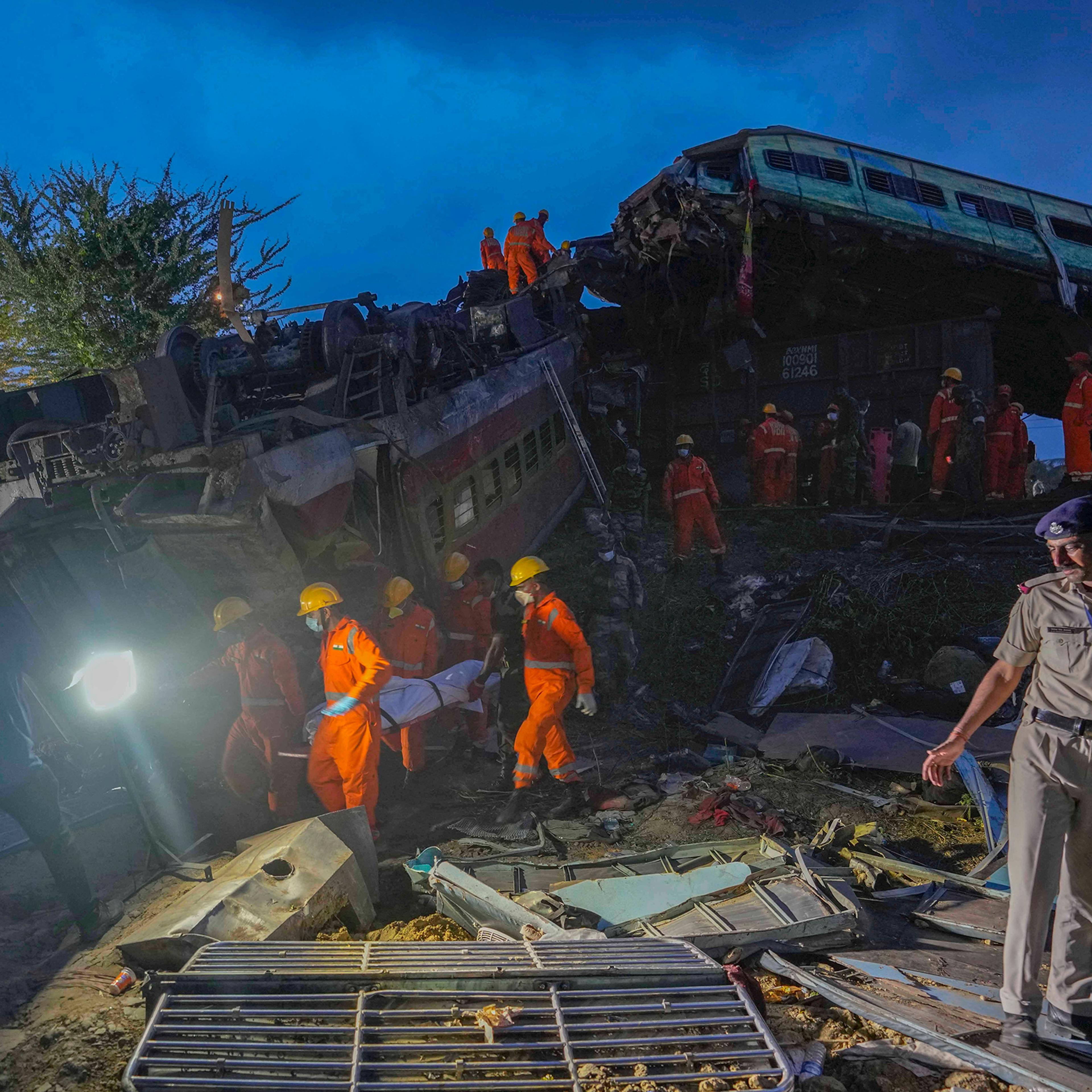 Rescuers carry the body of a victim at the site of passenger trains that derailed in Balasore, in the eastern Indian state of Orissa, India, on June 3.