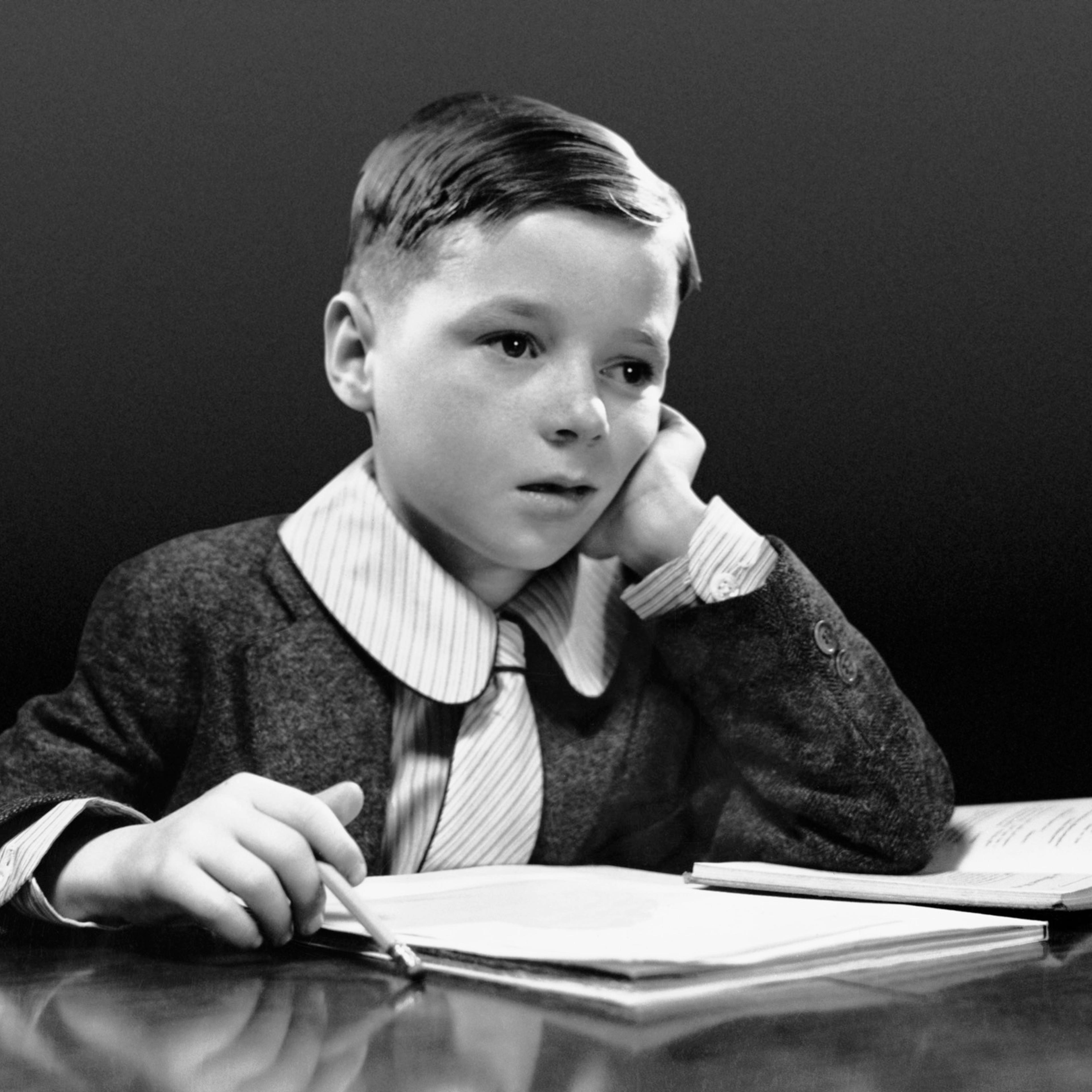 Boy sitting at desk w/book