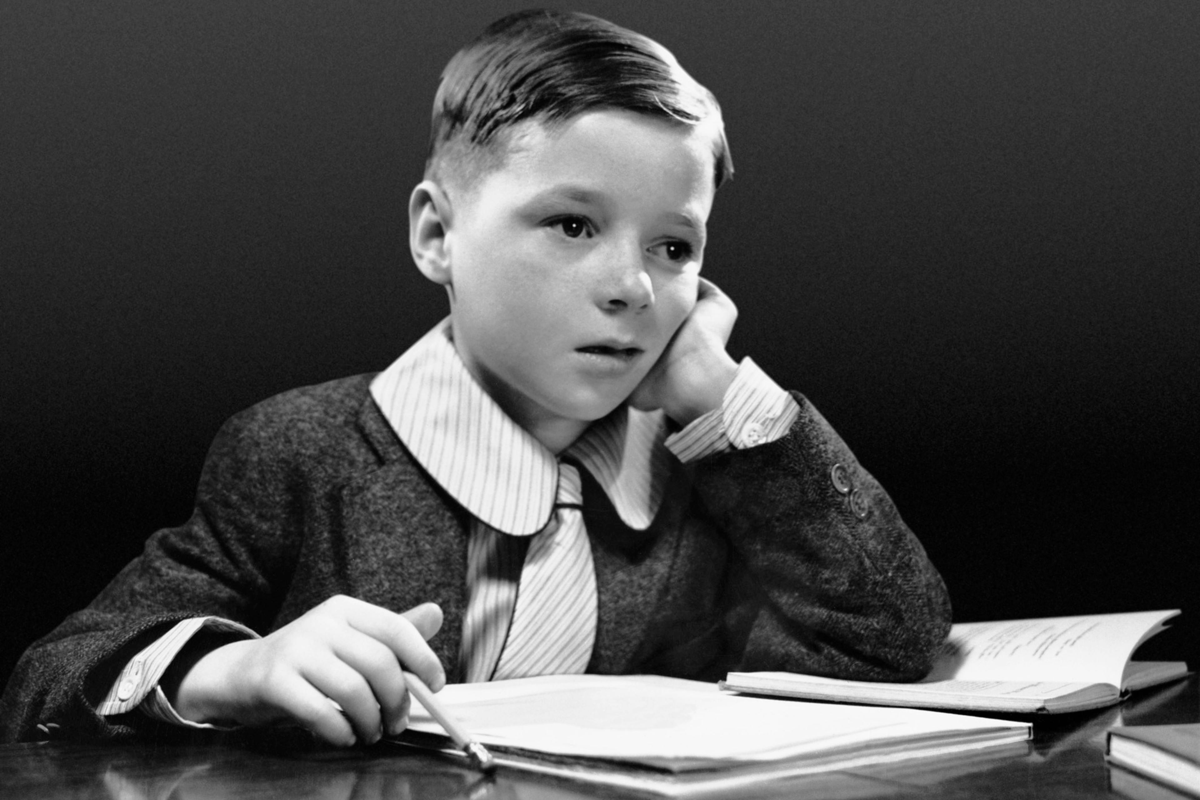 Boy sitting at desk w/book