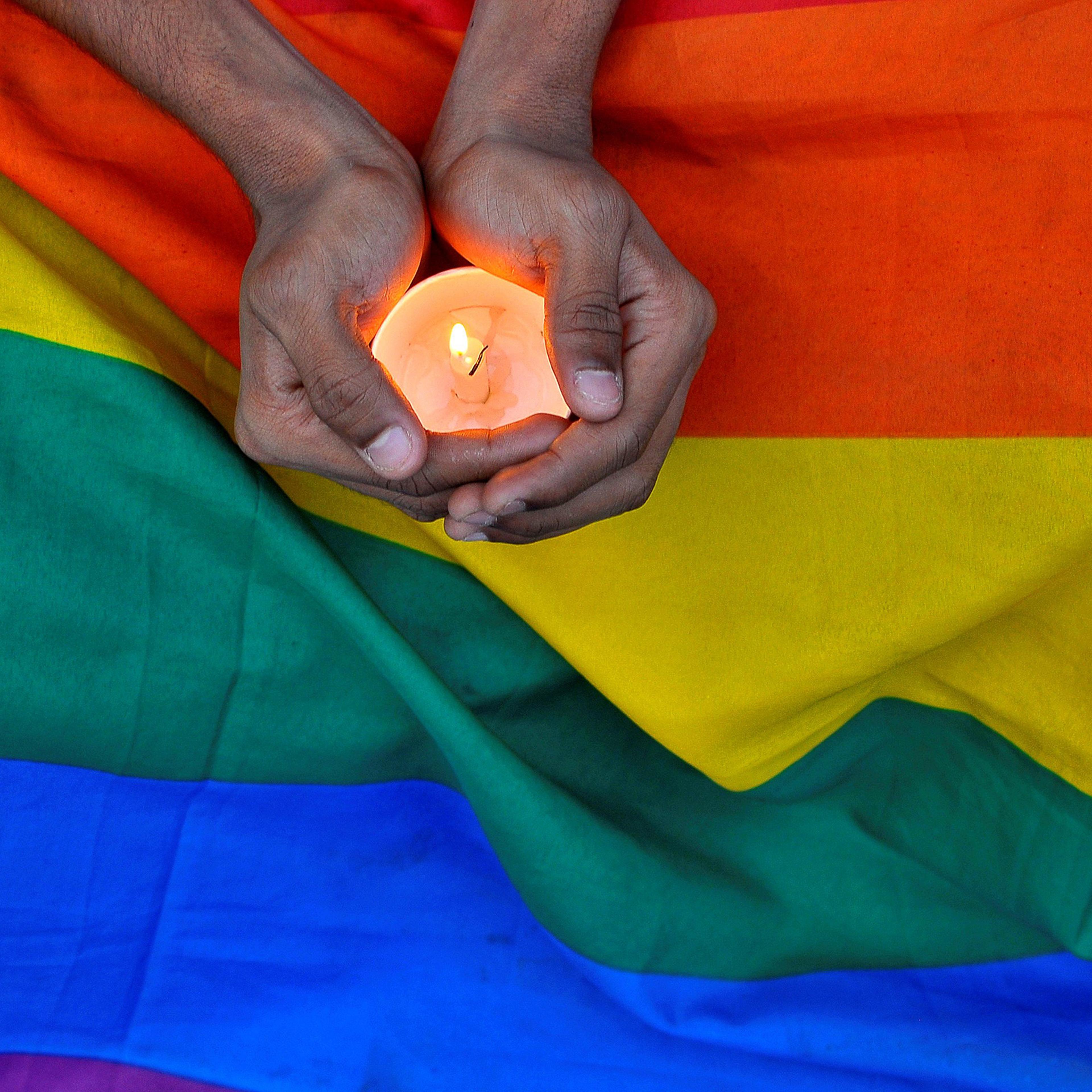 A member of the LGBT community in Bengalaru holds a candle during a memorial service following a mass shooting at the Pulse gay nightclub in Orlando, in India June 14, 2016.