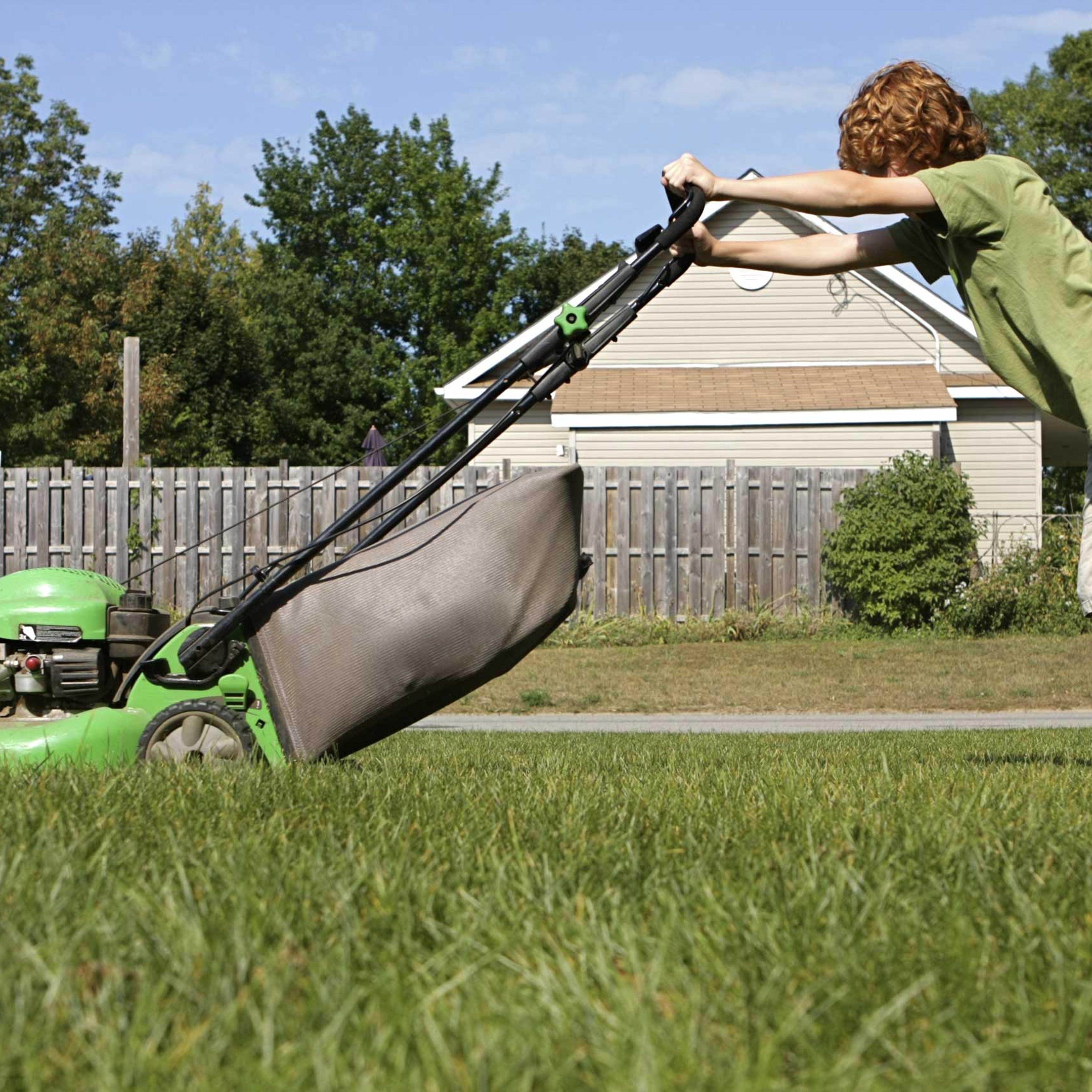 teenager mowing lawn