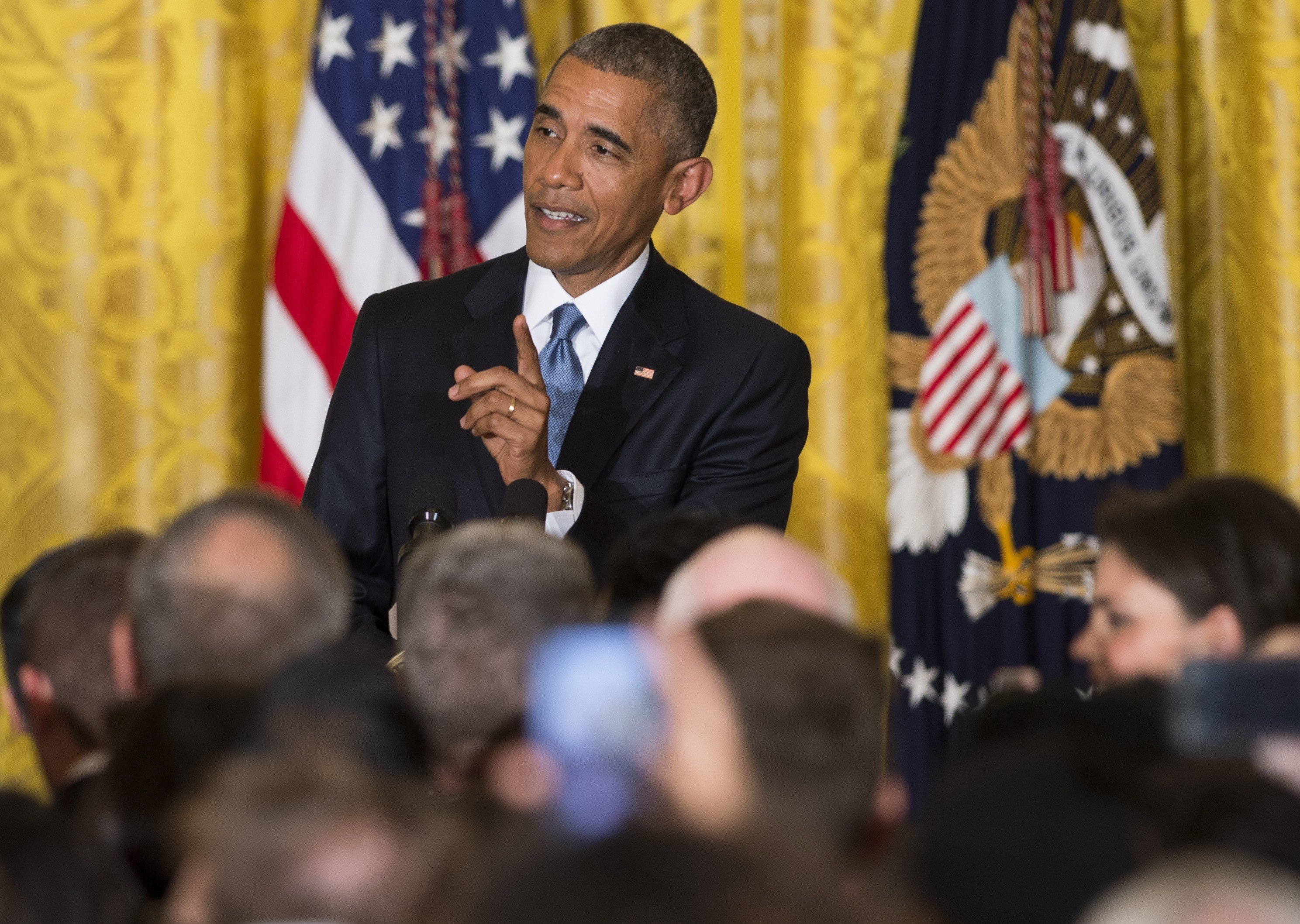 President Barack Obama responds to a heckler who interrupted his speech during a reception in honor of LGBT Pride Month in the East Room of the White House in Washington, DC on June 24, 2015.