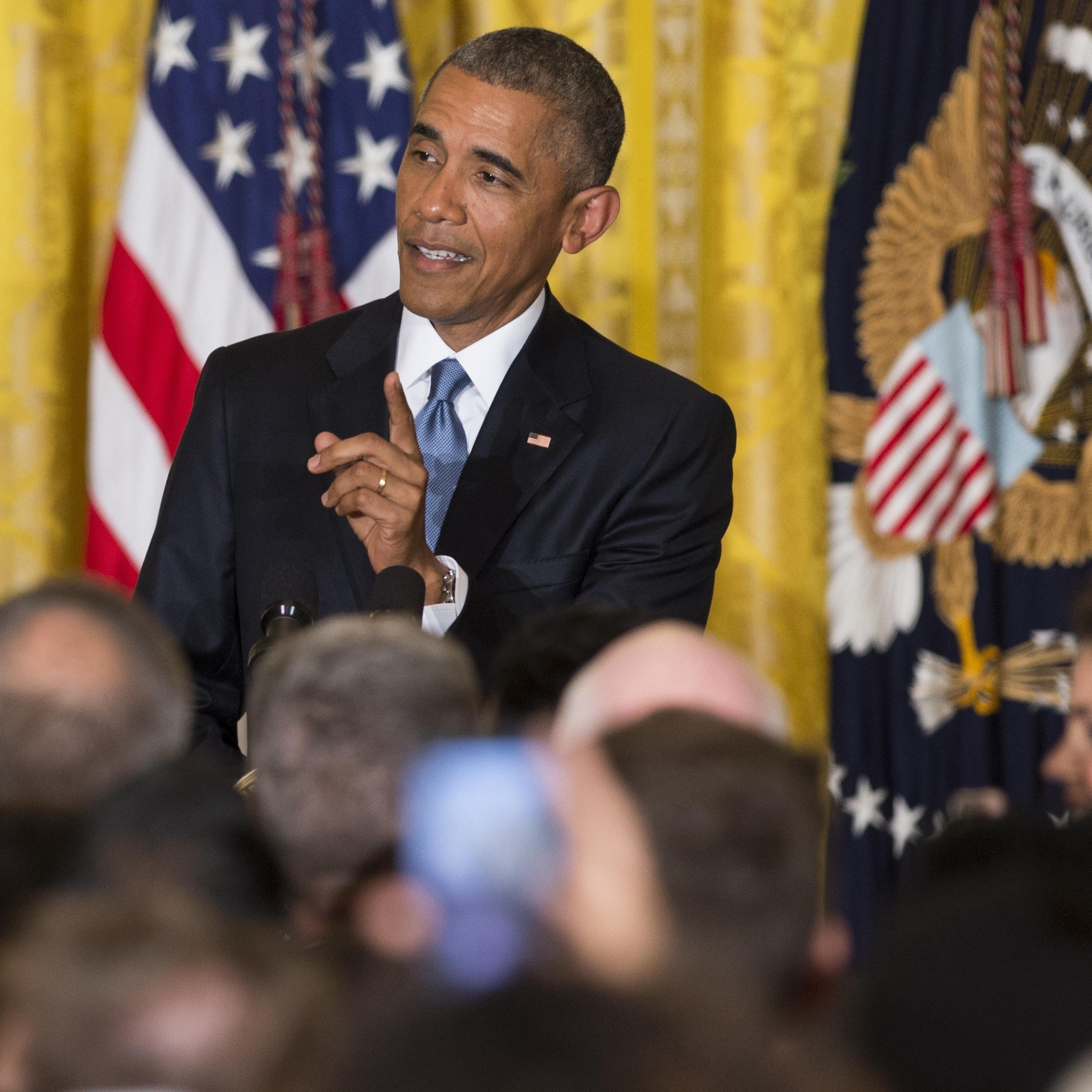 President Barack Obama responds to a heckler who interrupted his speech during a reception in honor of LGBT Pride Month in the East Room of the White House in Washington, DC on June 24, 2015.