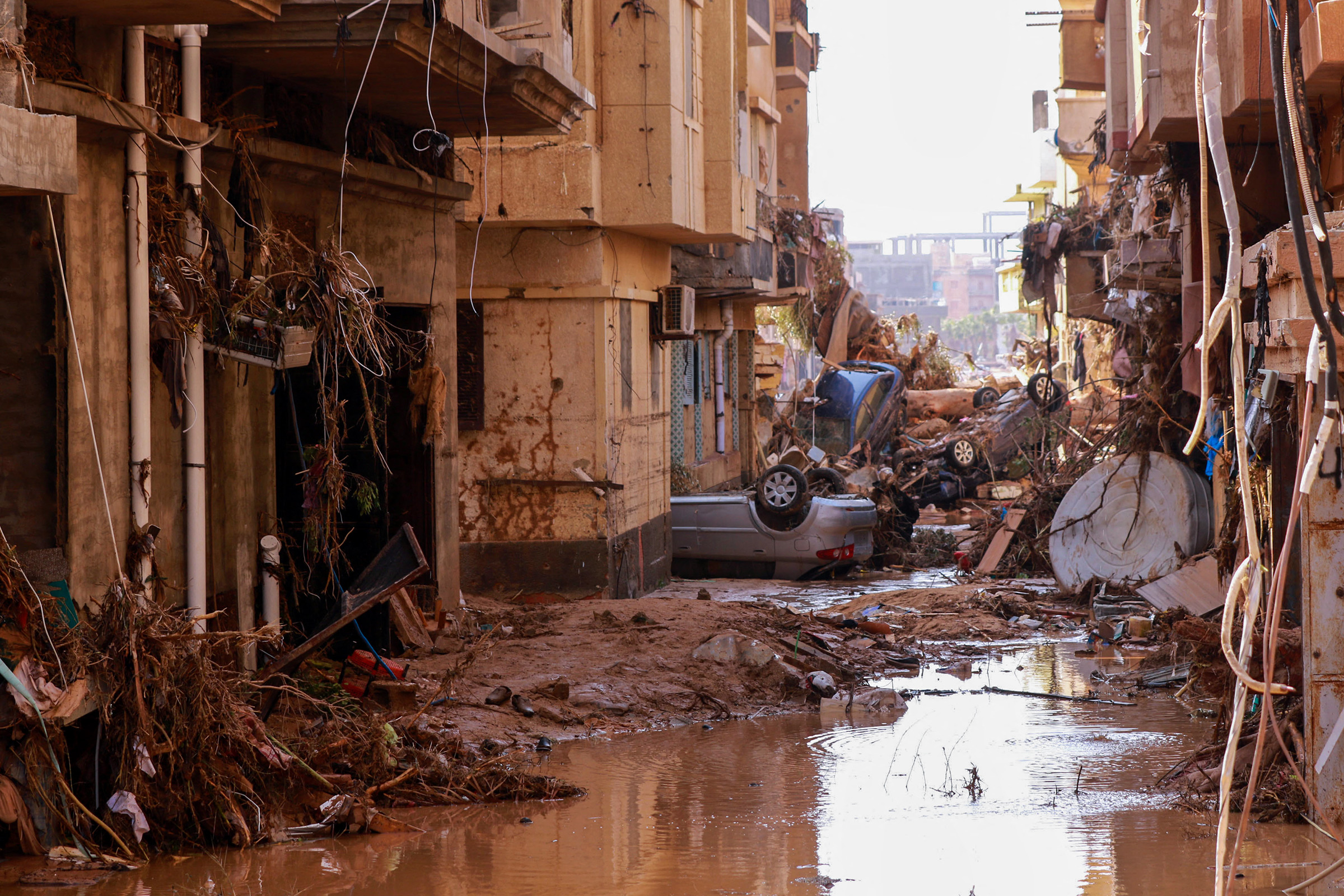 Overturned cars lay among other debris caused by flash floods in Derna, eastern Libya, on Sept. 11.