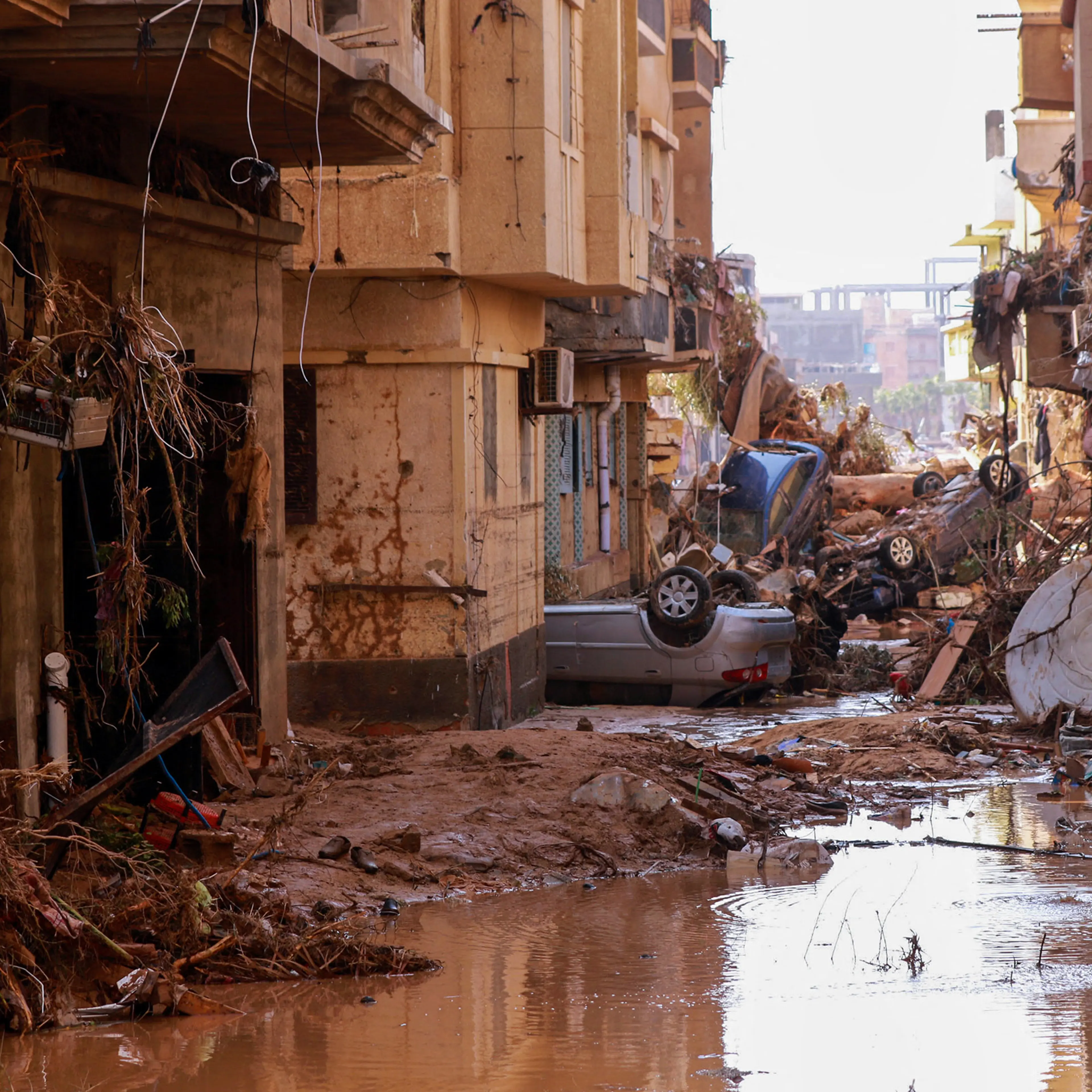 Overturned cars lay among other debris caused by flash floods in Derna, eastern Libya, on Sept. 11.