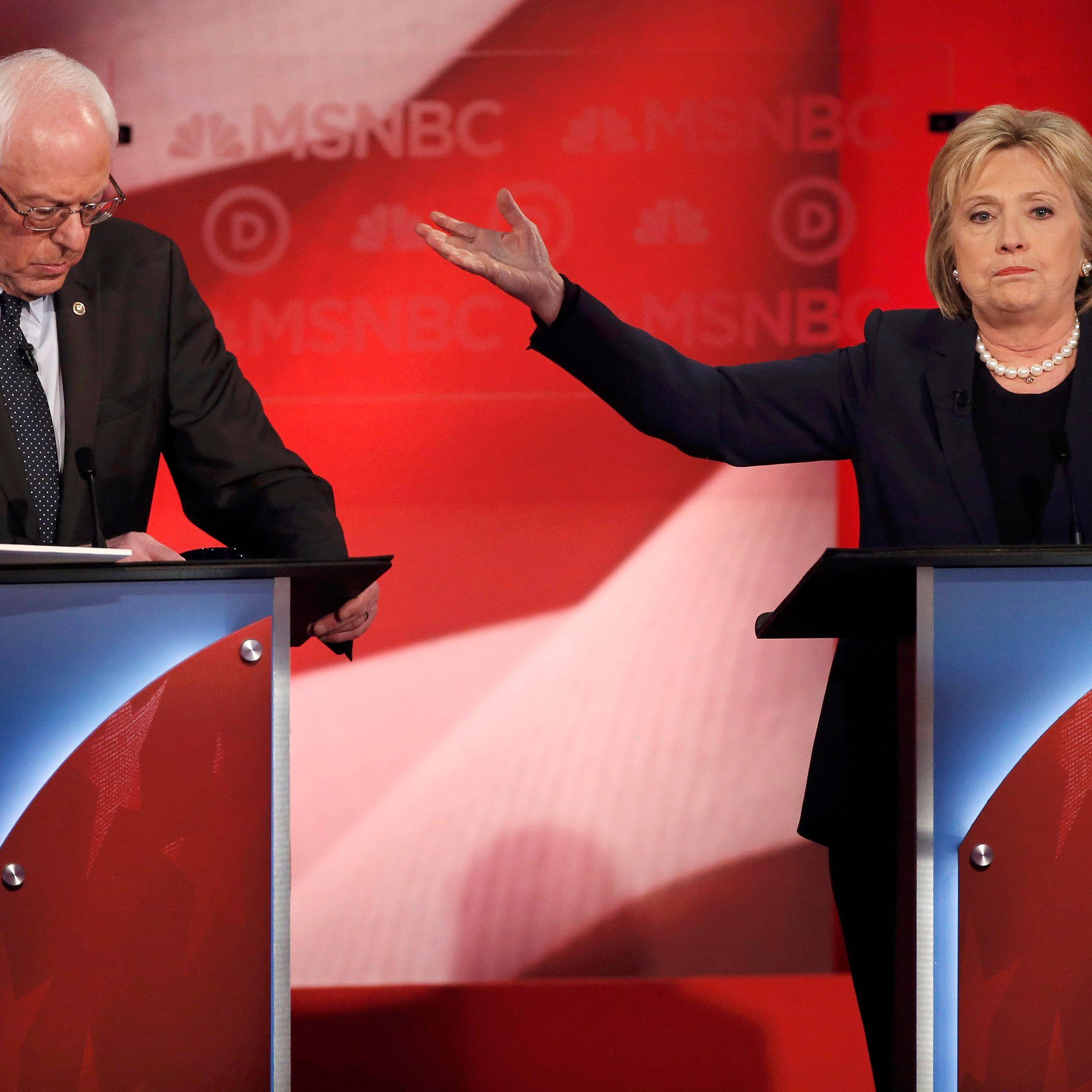 Democratic U.S. presidential candidate and former Secretary of State Clinton talks about Senator Sanders as they discuss issues during the Democratic presidential candidates debate sponsored by MSNBC at the University of New Hampshire in Durham