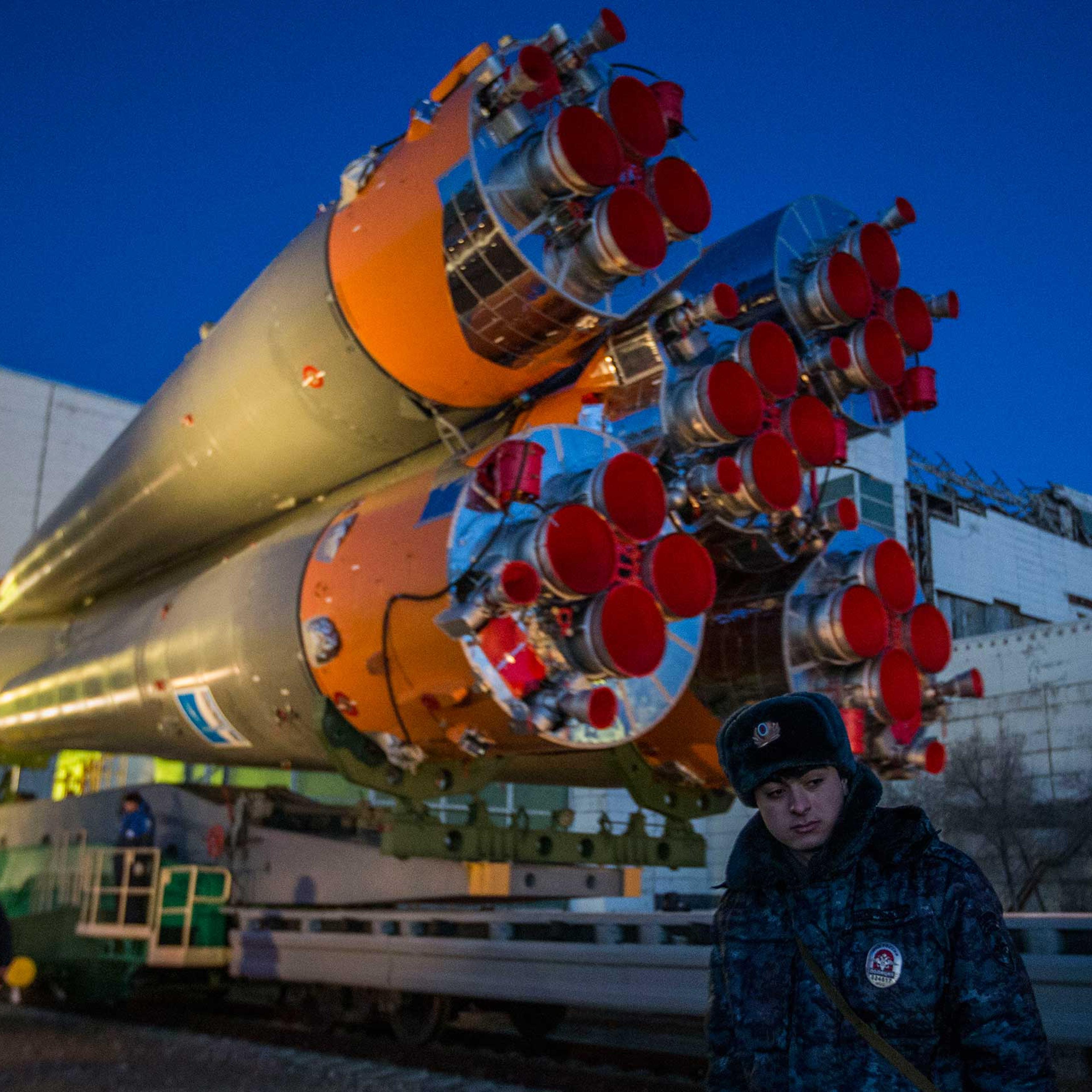 A member of the Russian guard stands in front of the Soyuz as it is rolled out for launch at the Baikonur Cosmodrome in Kazakhstan on Wednesday, March 25.