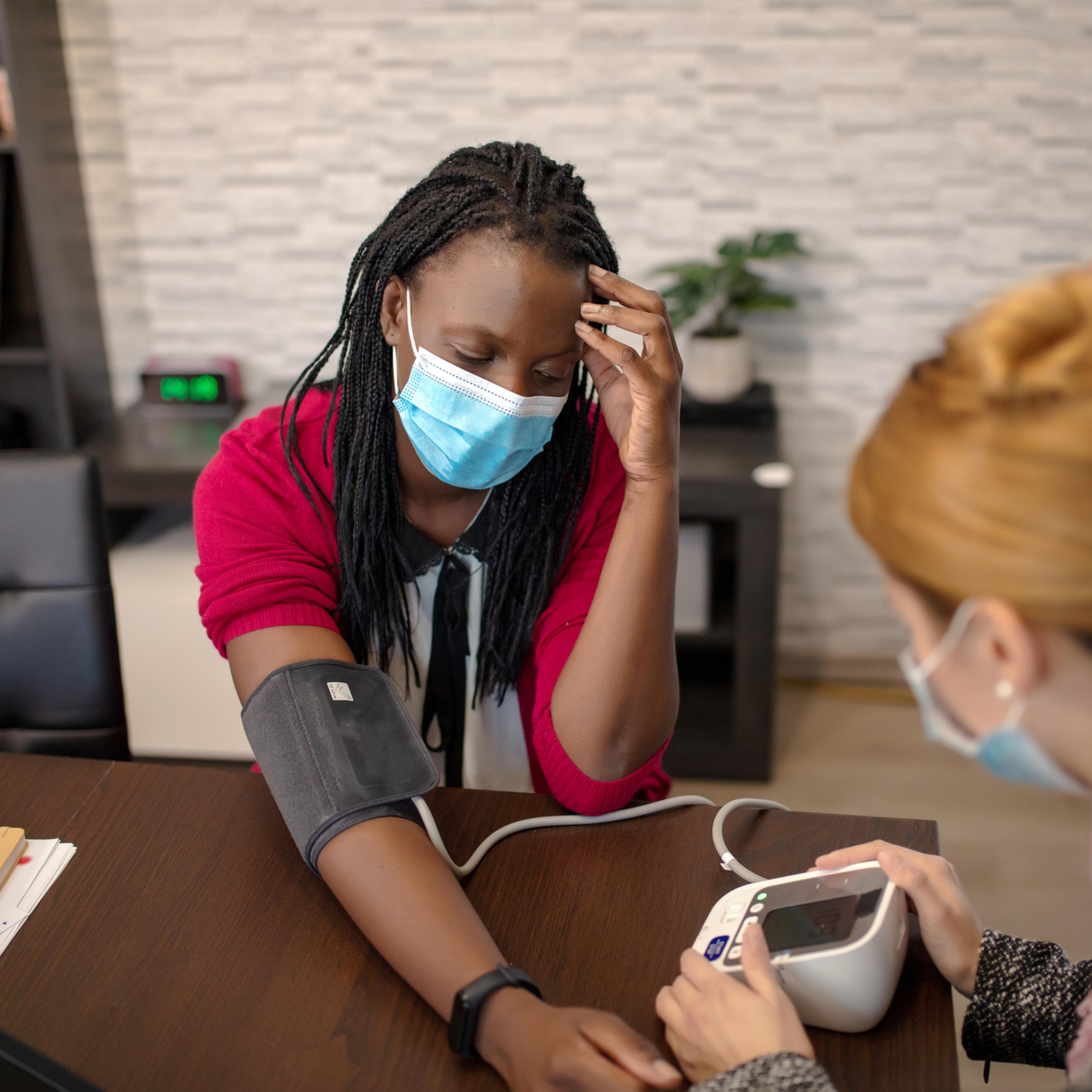 Doctor seeing patient in mask