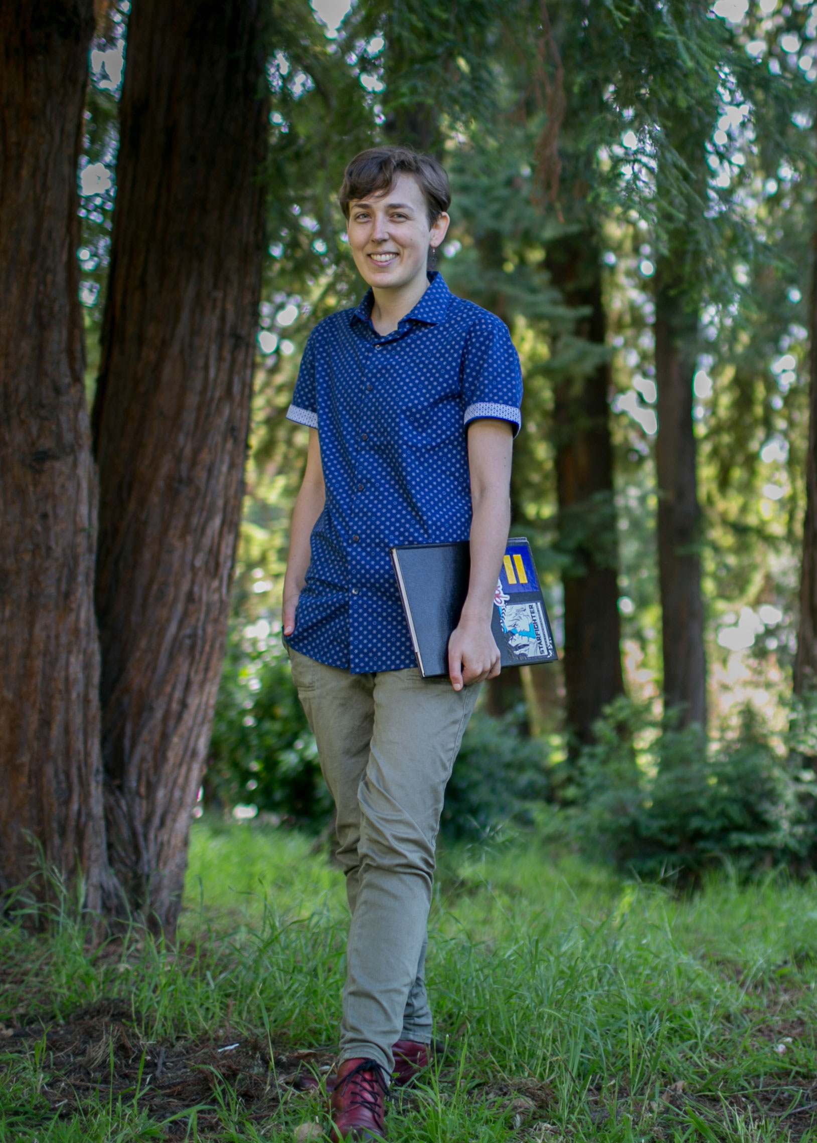 Portrait of Maia Kobabe wearing a blue button-up shirt