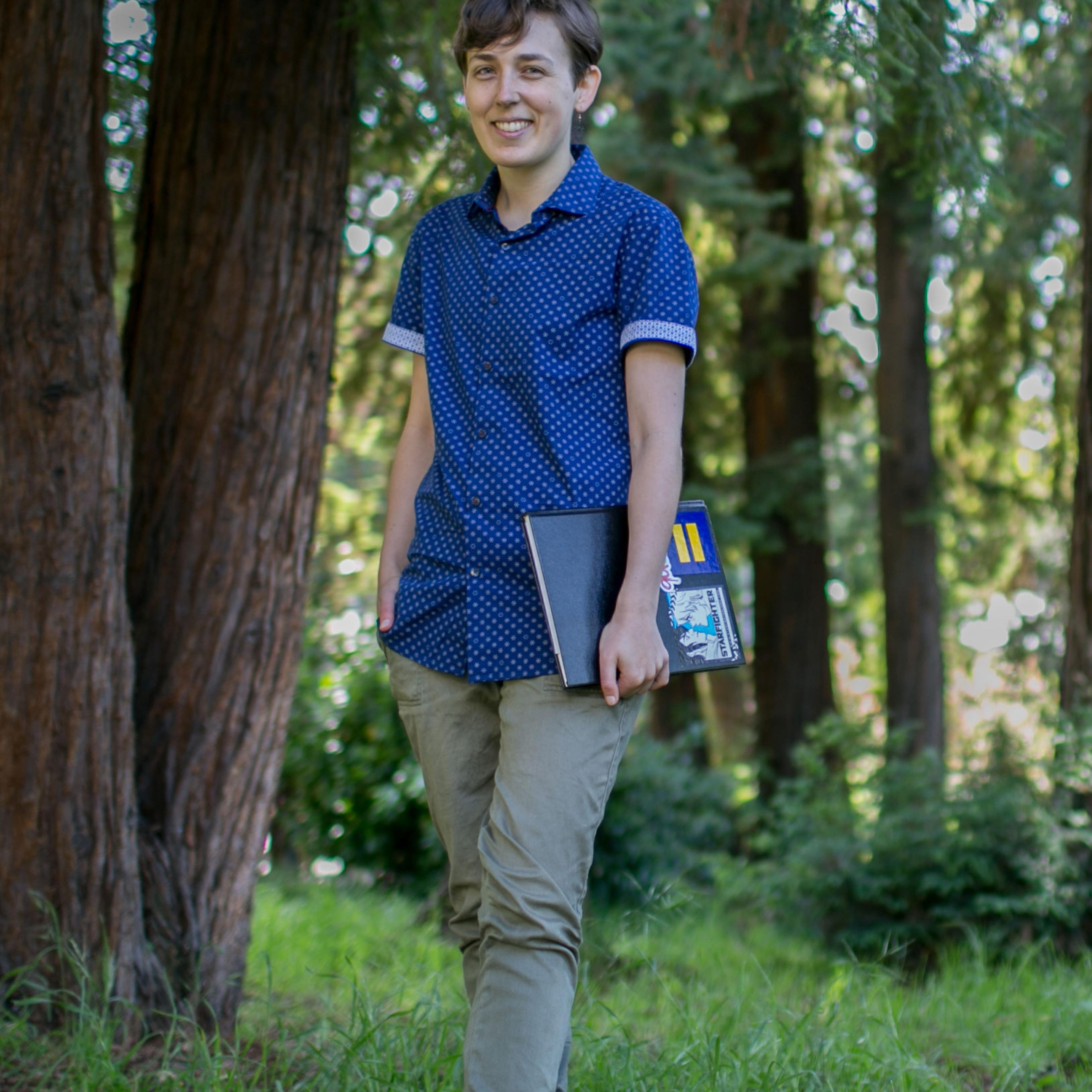 Portrait of Maia Kobabe wearing a blue button-up shirt