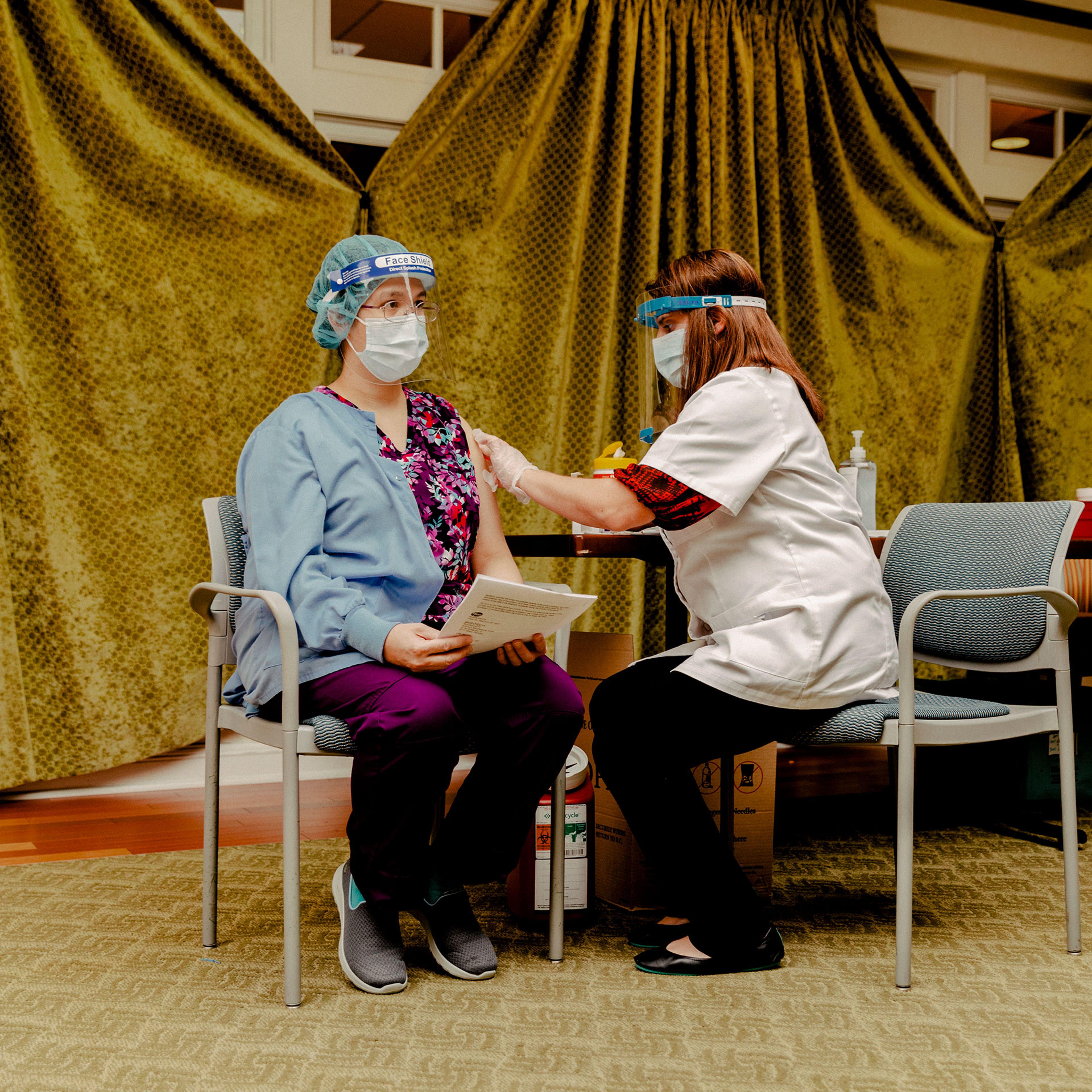 An employee of Westminster Place is vaccinated on Jan. 6, 2021.