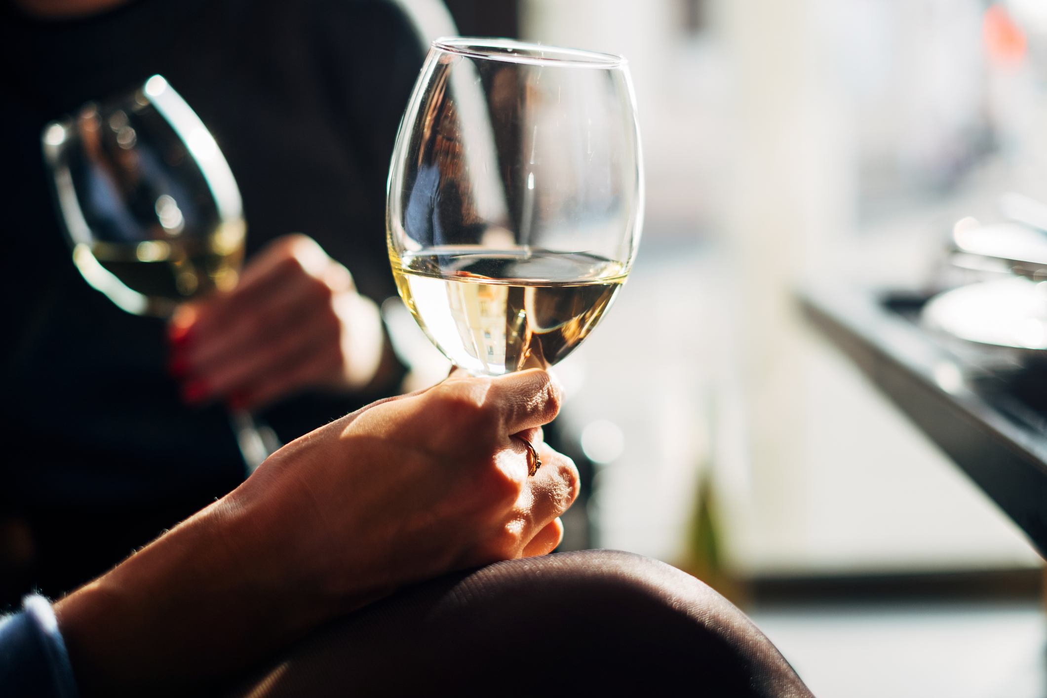 Two women sitting at a table enjoying a glass of wine