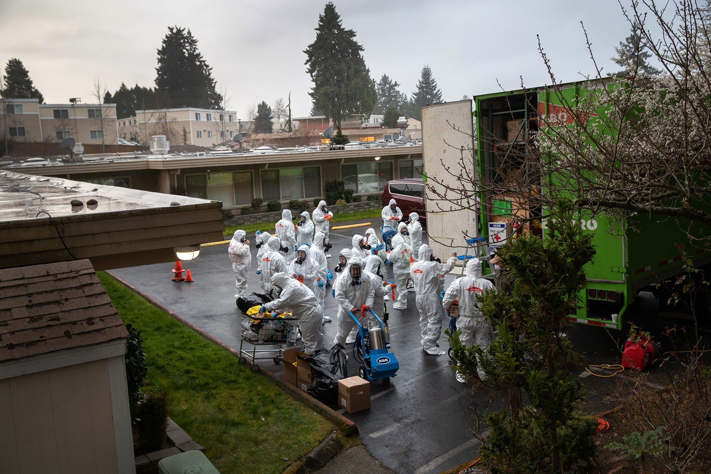 A cleaning crew suits up in protective clothing before entering the Life Care Center on March 12 in Kirkland, Washington. The nursing home in the Seattle suburbs has had the most coronavirus deaths of anywhere in the United States.