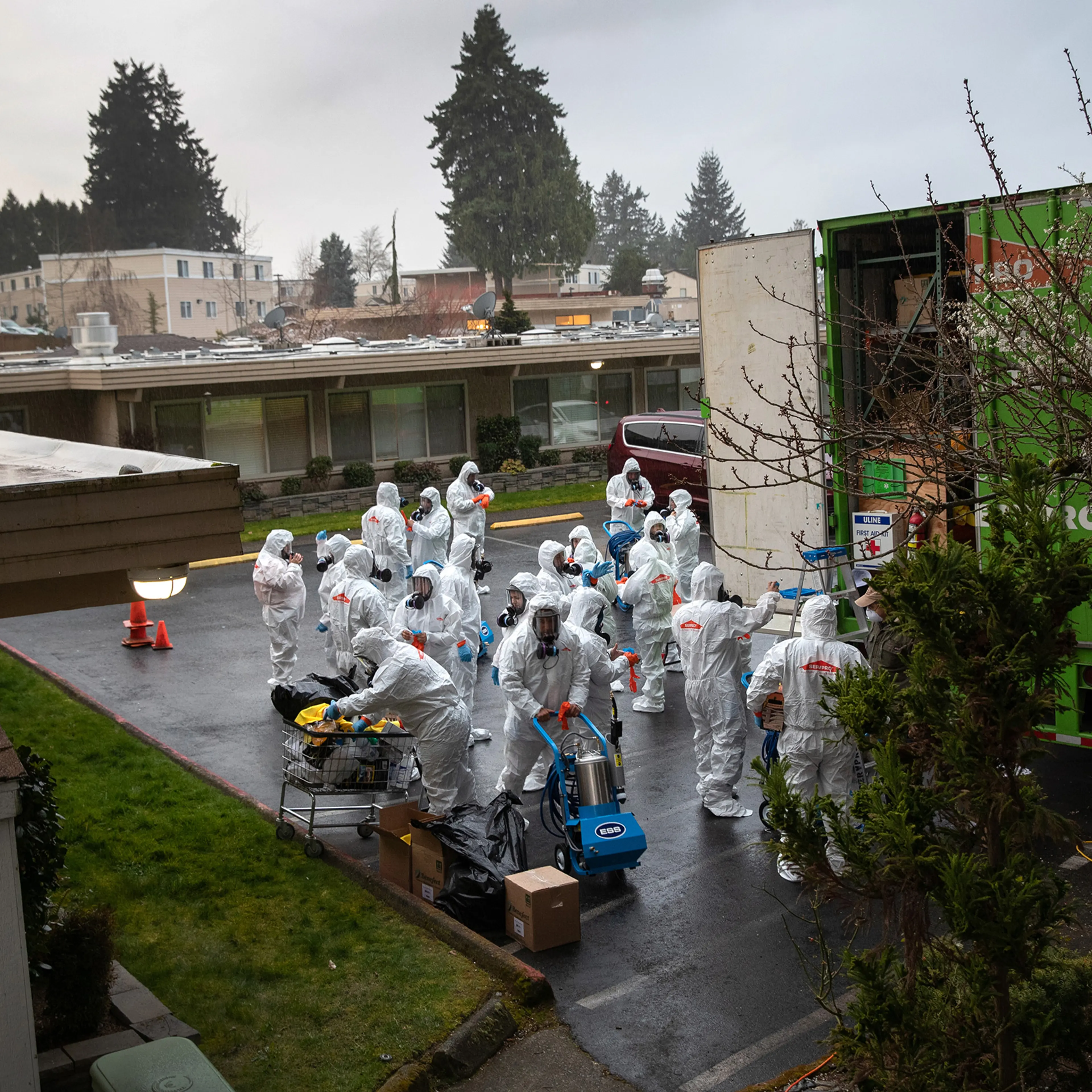 A cleaning crew suits up in protective clothing before entering the Life Care Center on March 12 in Kirkland, Washington. The nursing home in the Seattle suburbs has had the most coronavirus deaths of anywhere in the United States.